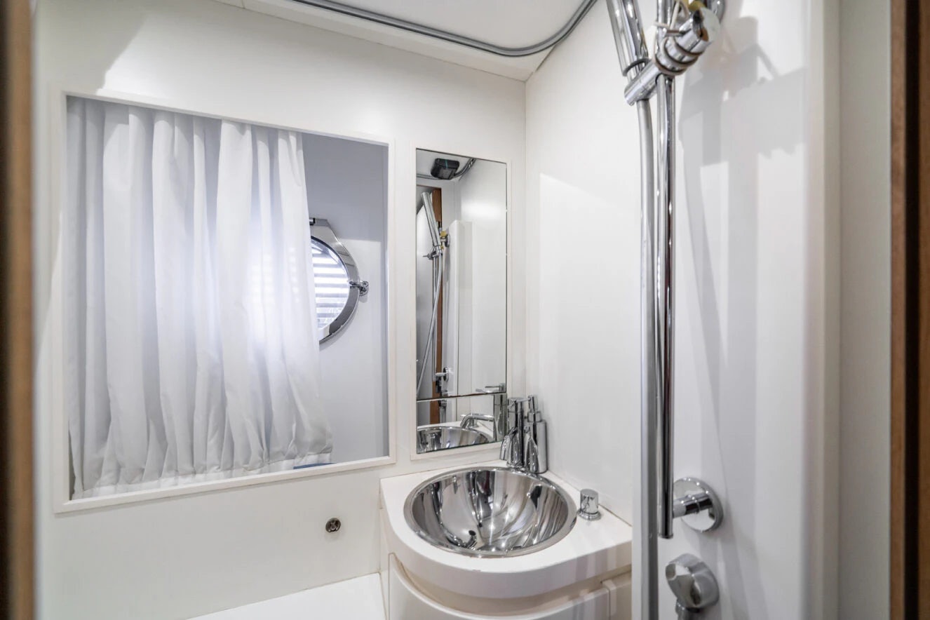 a bathroom with a sink and a shower unit aboard XANADU 76 Yacht for Sale