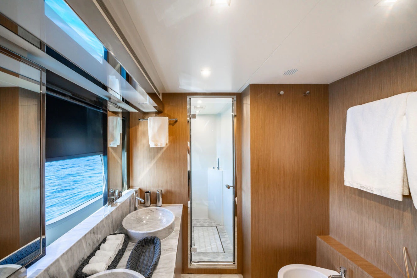 a bathroom with a sink and a shower unit aboard XANADU 76 Yacht for Sale