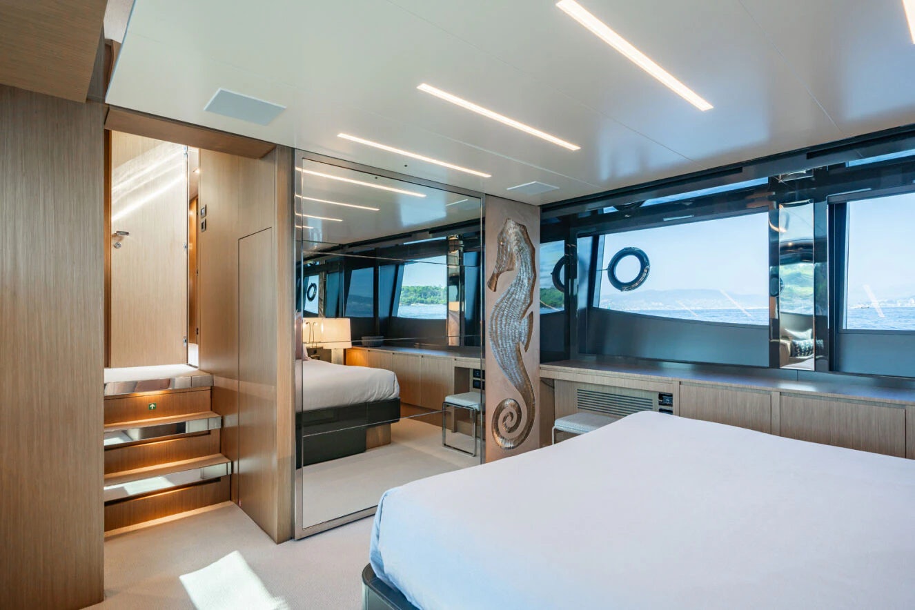 a room with a bed and a desk aboard XANADU 76 Yacht for Sale