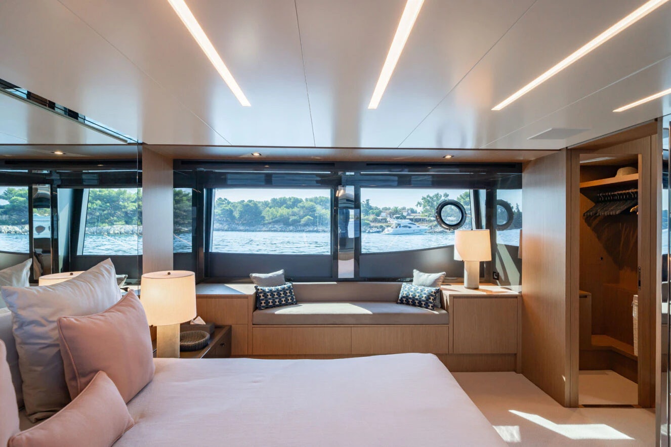 a room with a bed and a large window aboard XANADU 76 Yacht for Sale