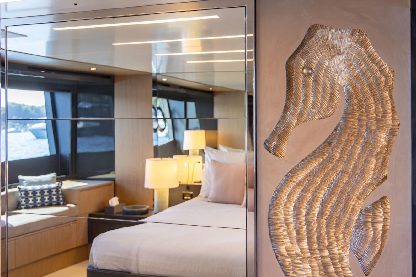 a room with a bed and a lamp aboard XANADU 76 Yacht for Sale