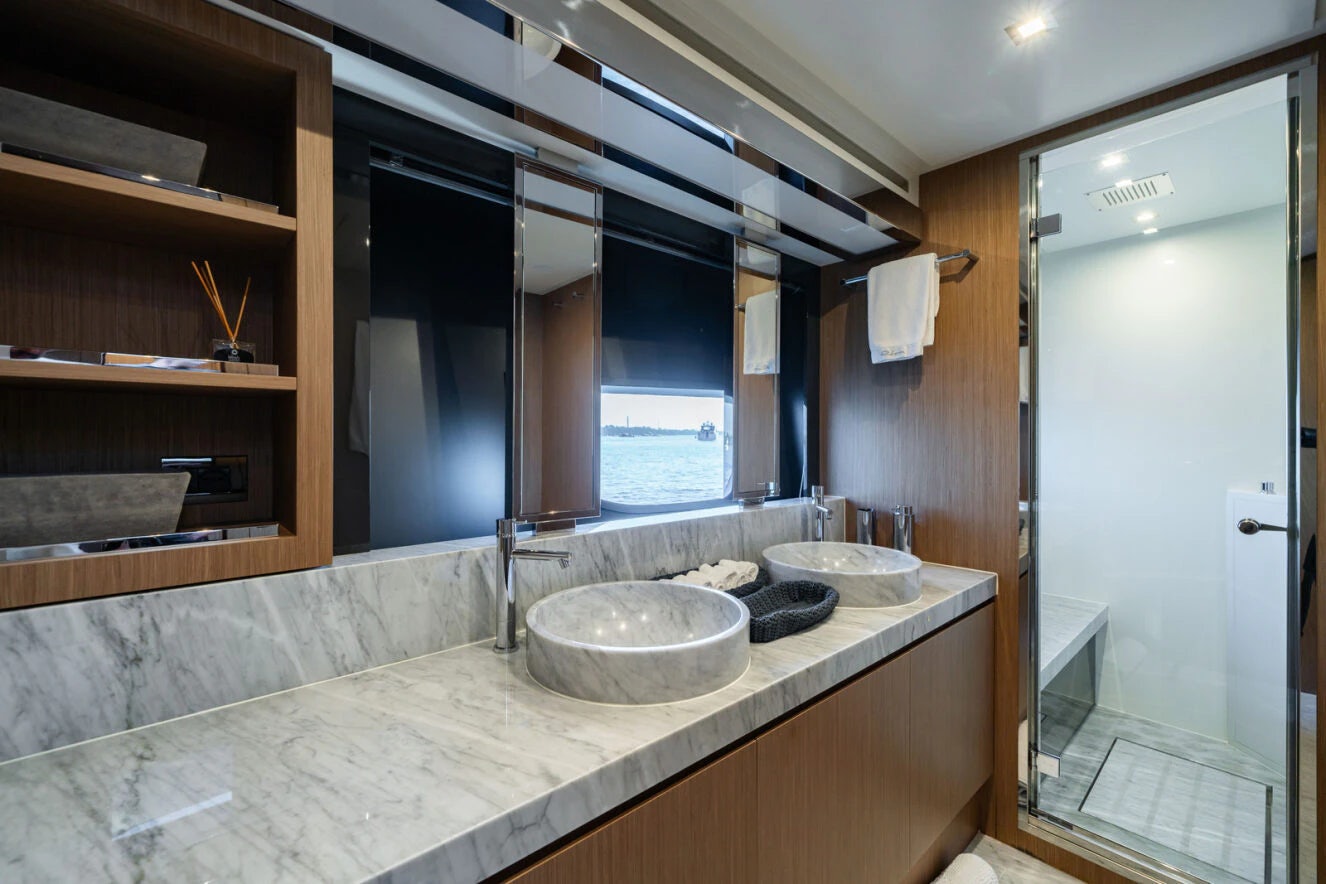a bathroom with sinks and mirrors aboard XANADU 76 Yacht for Sale