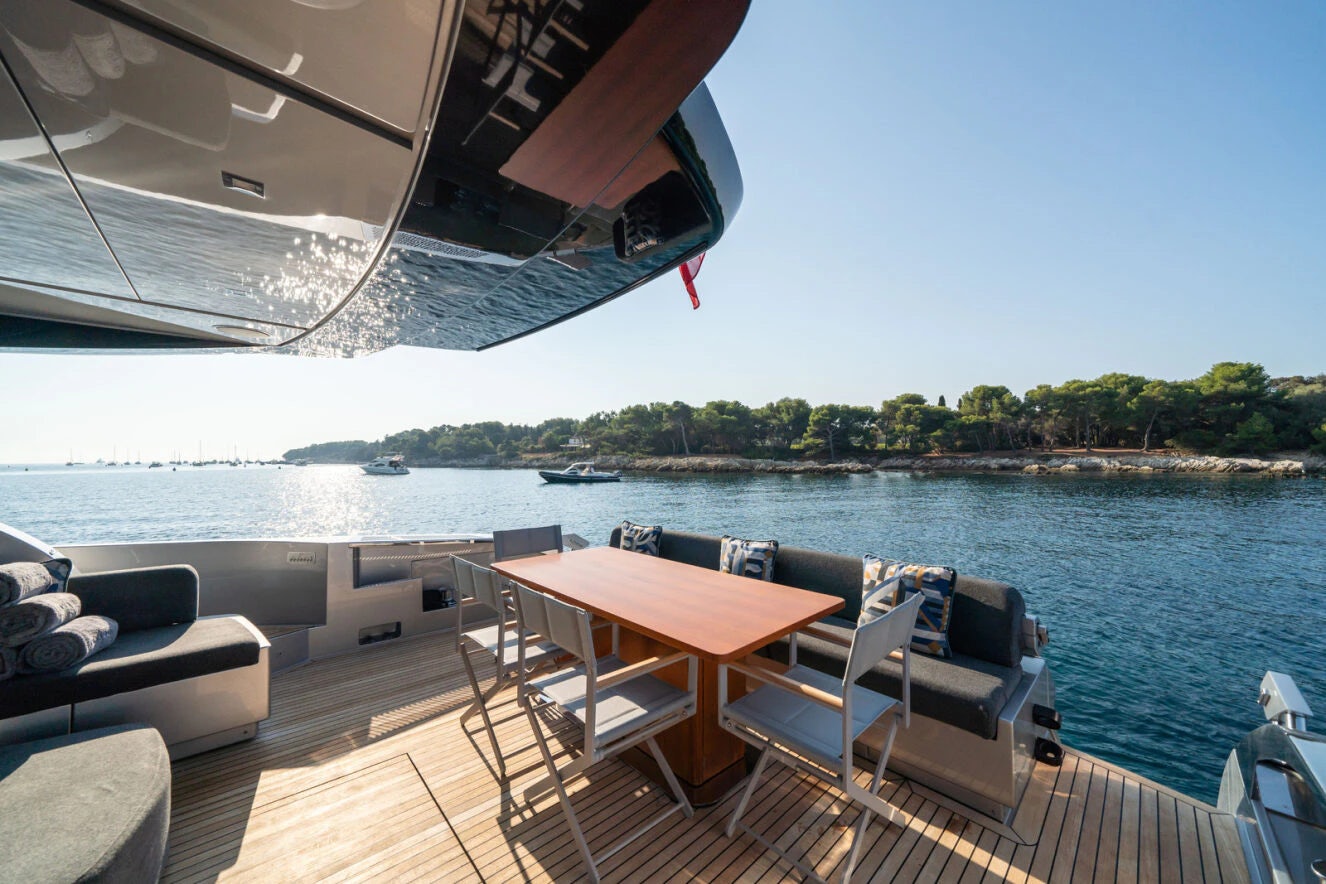 a table and chairs on a boat aboard XANADU 76 Yacht for Sale