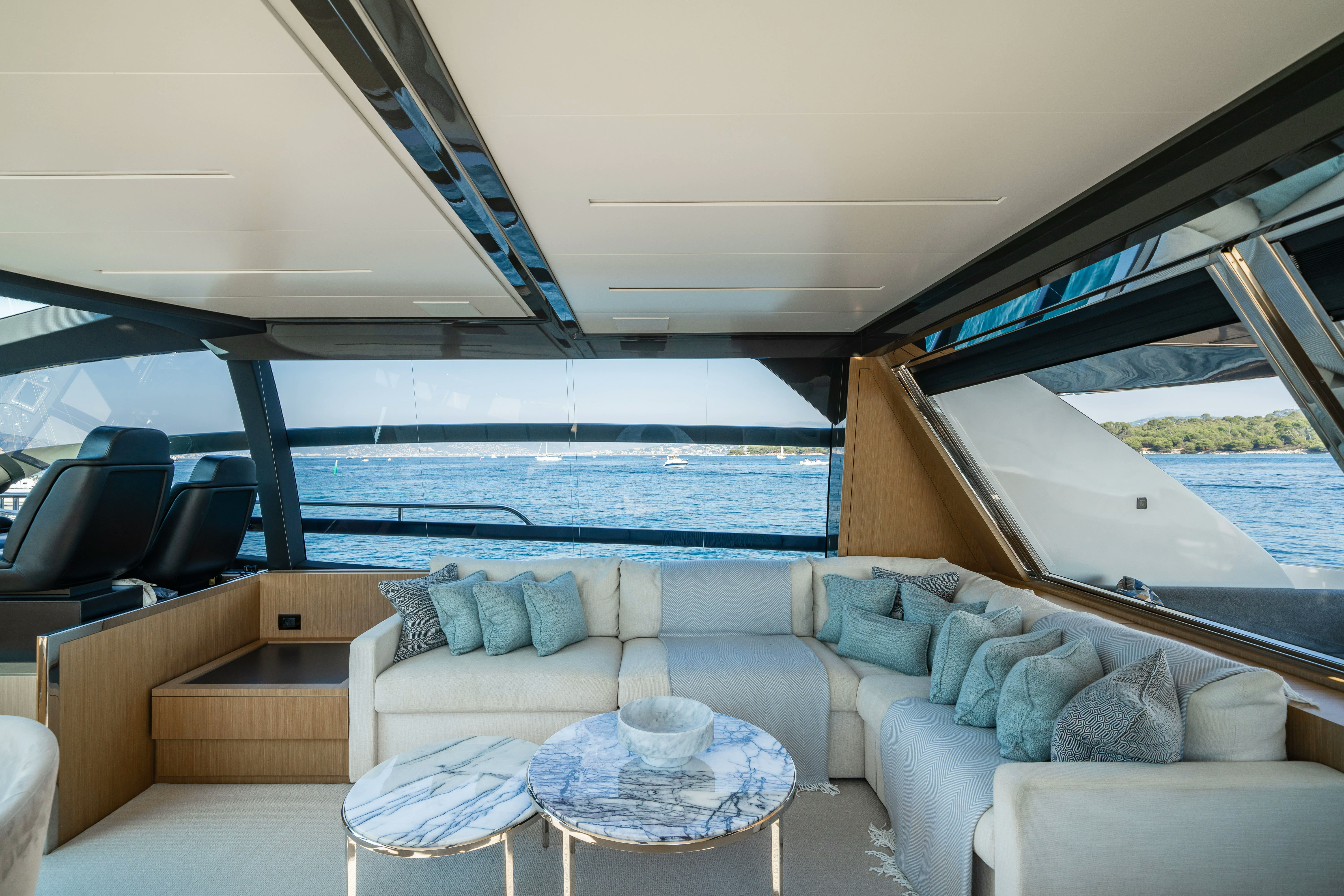 a living room with a large blue ocean aboard XANADU 76 Yacht for Sale