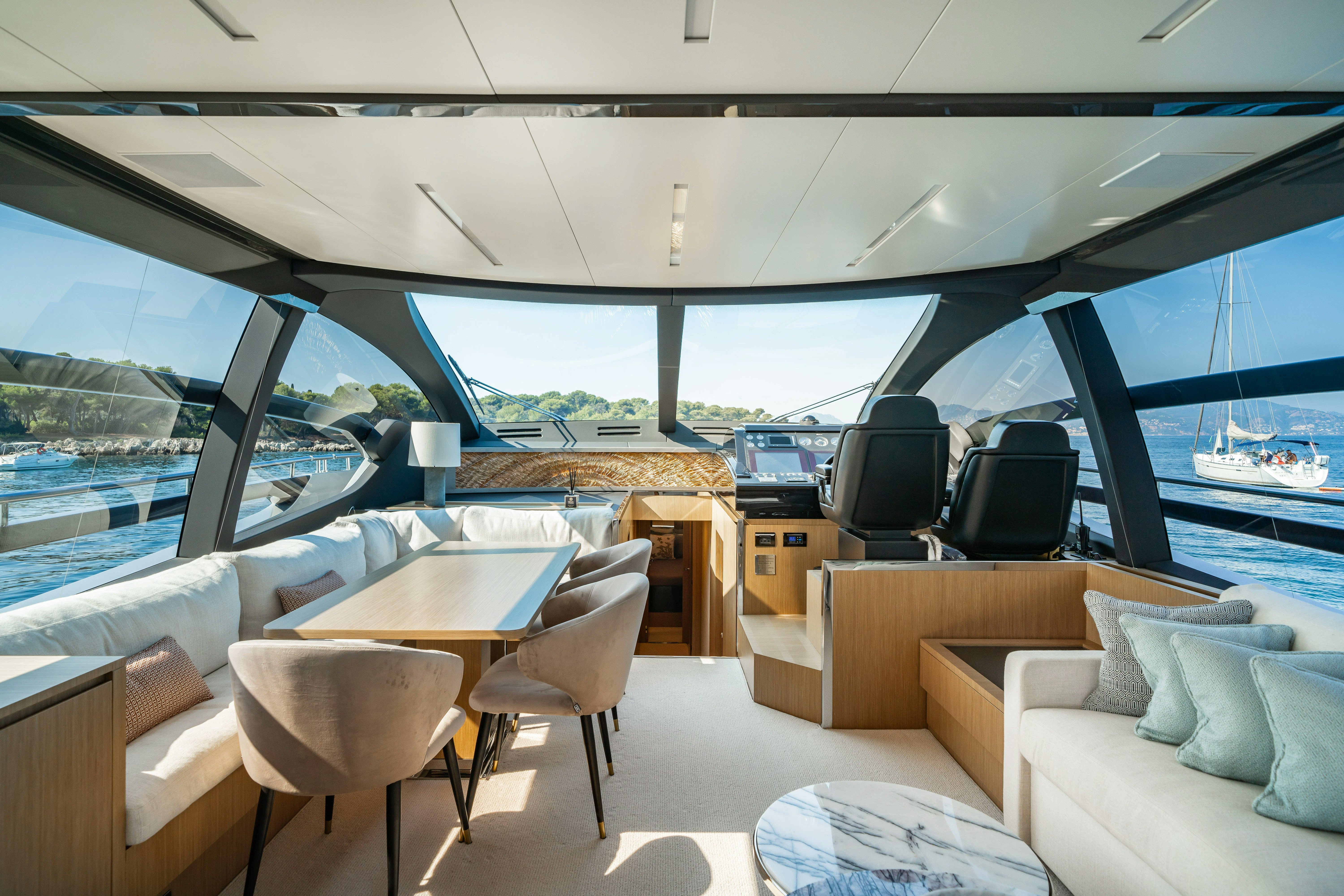 a room with a table and chairs aboard XANADU 76 Yacht for Sale