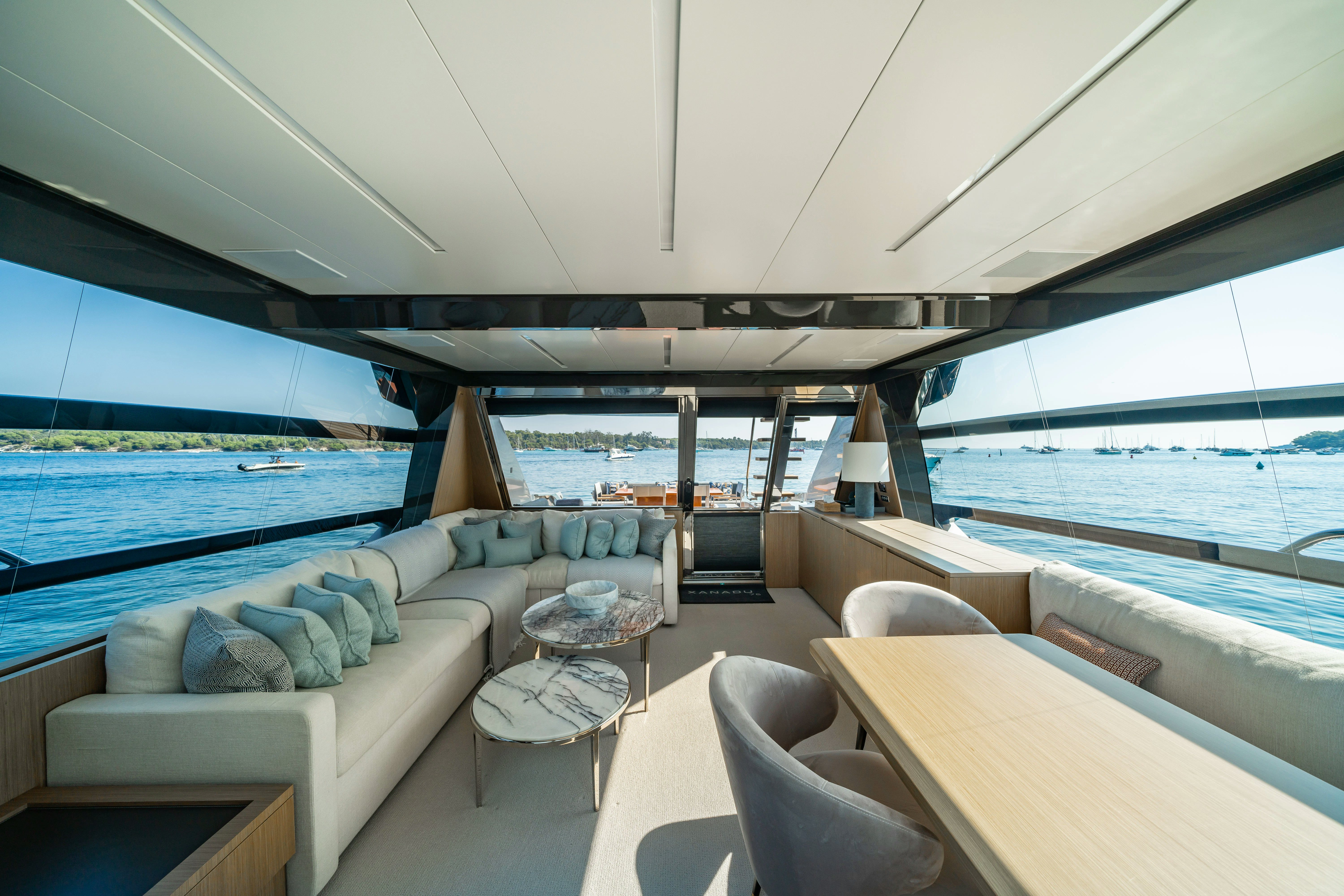 a large living room with a large swimming pool aboard XANADU 76 Yacht for Sale