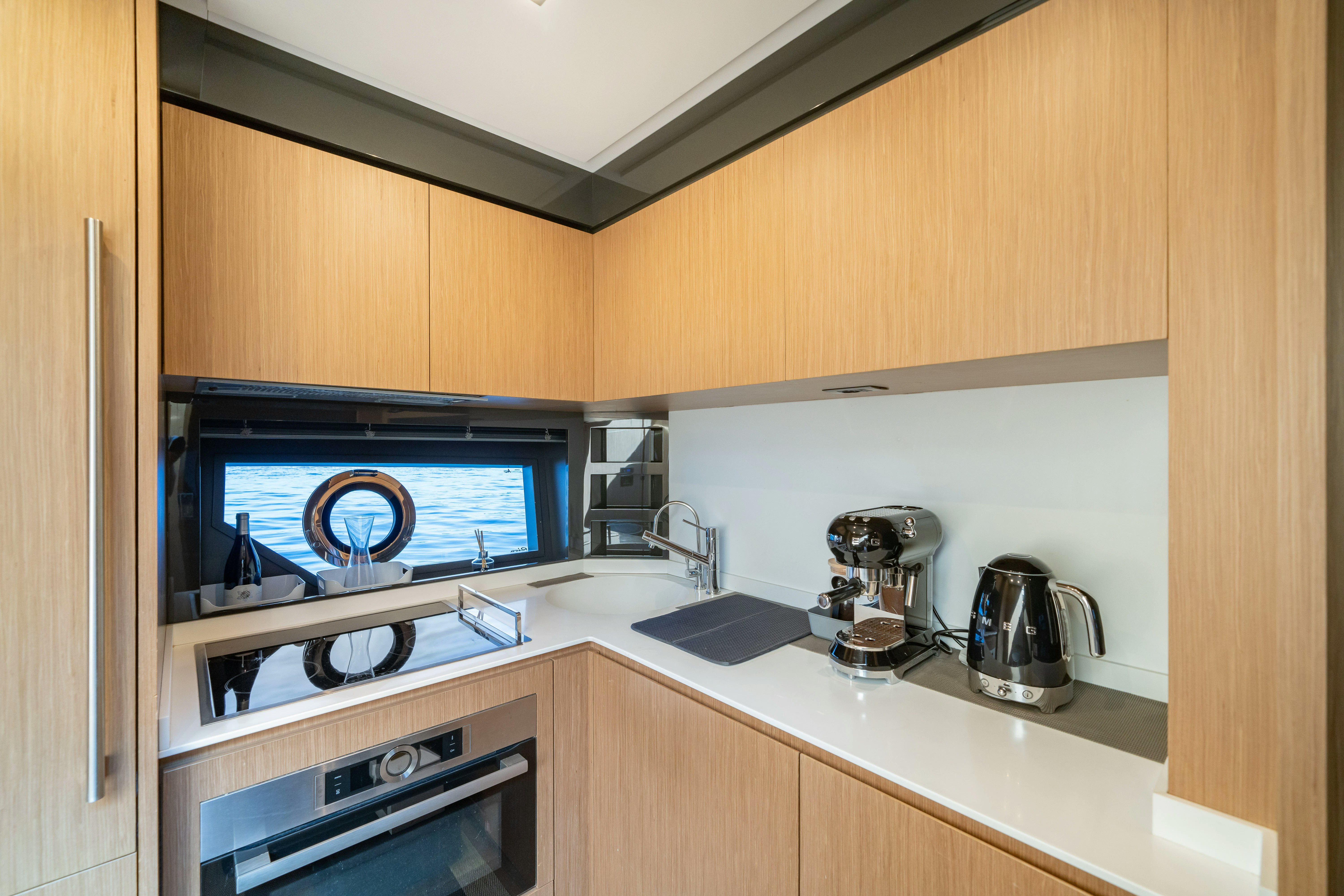 a microwave oven and a coffee maker in a kitchen aboard XANADU 76 Yacht for Sale