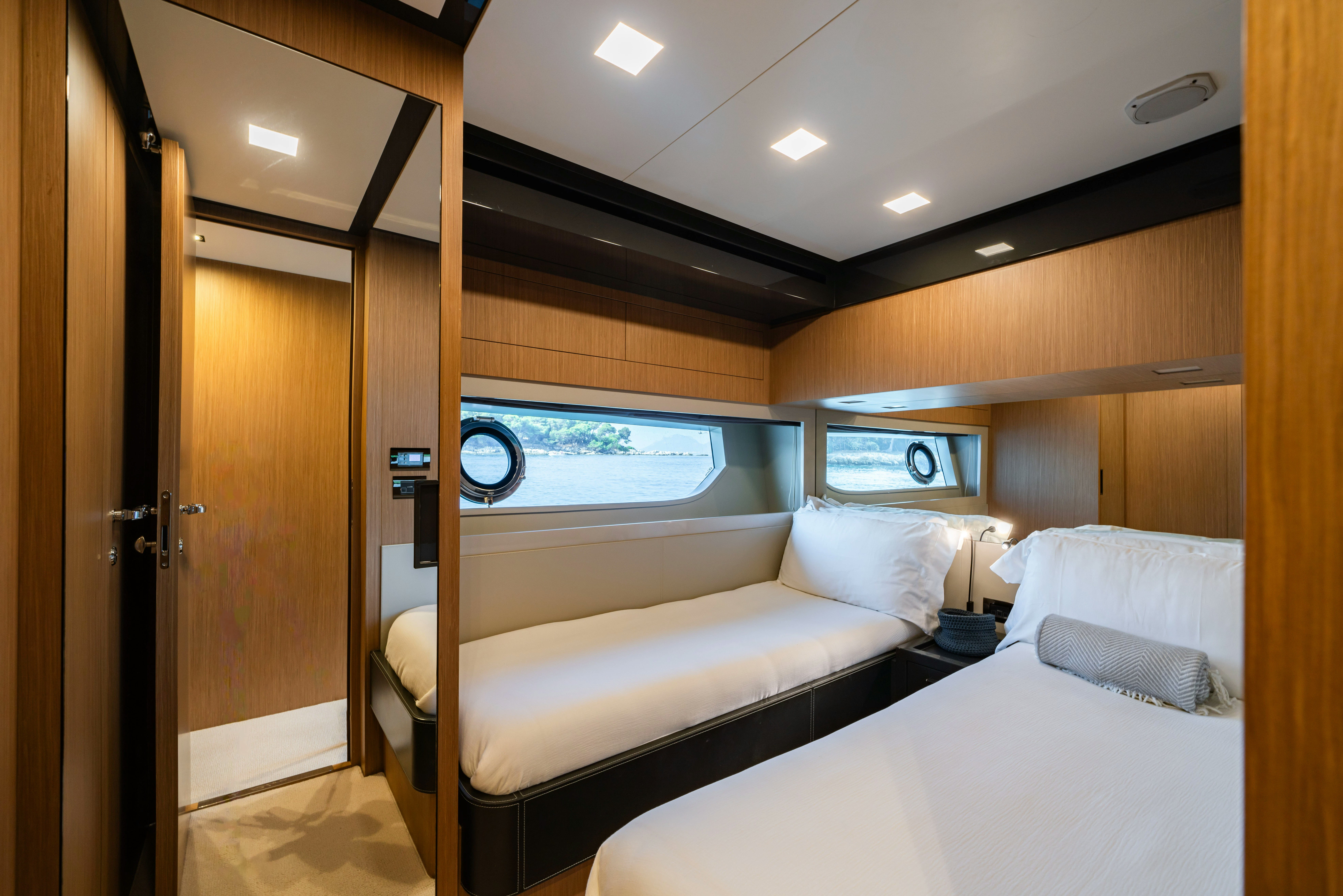 a room with a bed and a television aboard XANADU 76 Yacht for Sale