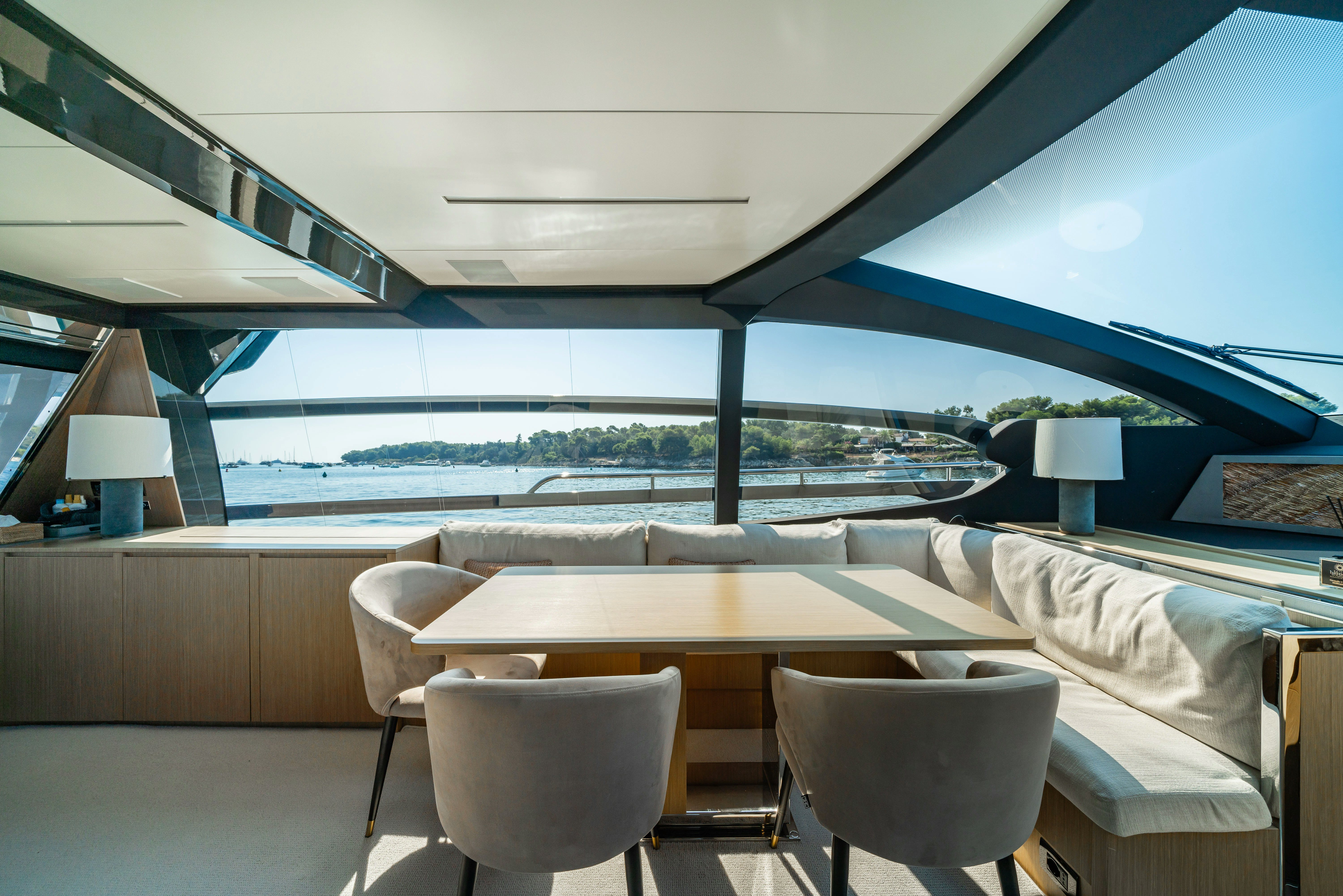 a room with a table and chairs aboard XANADU 76 Yacht for Sale