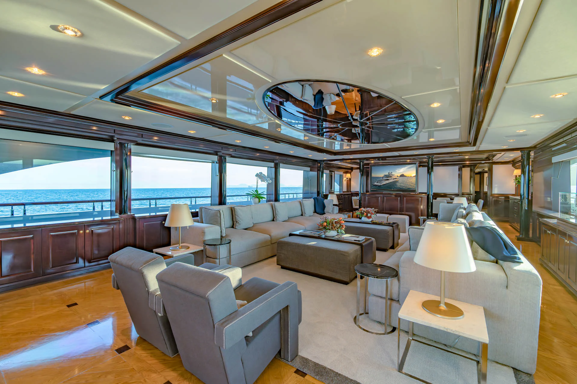 a large living room with a chandelier aboard SWEET CAROLINE II Yacht for Sale