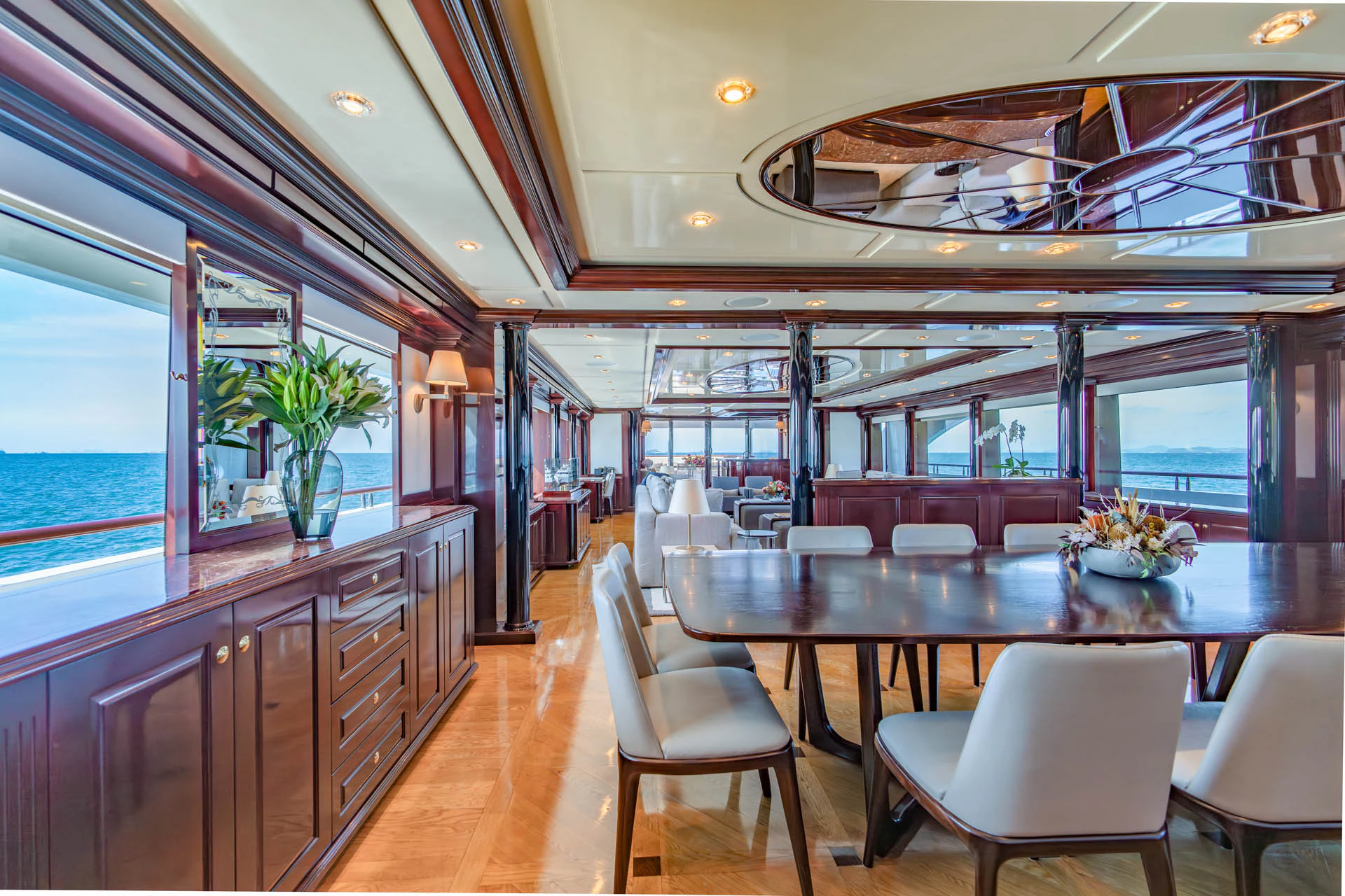 a large kitchen with a large dining table and chairs aboard SWEET CAROLINE II Yacht for Sale