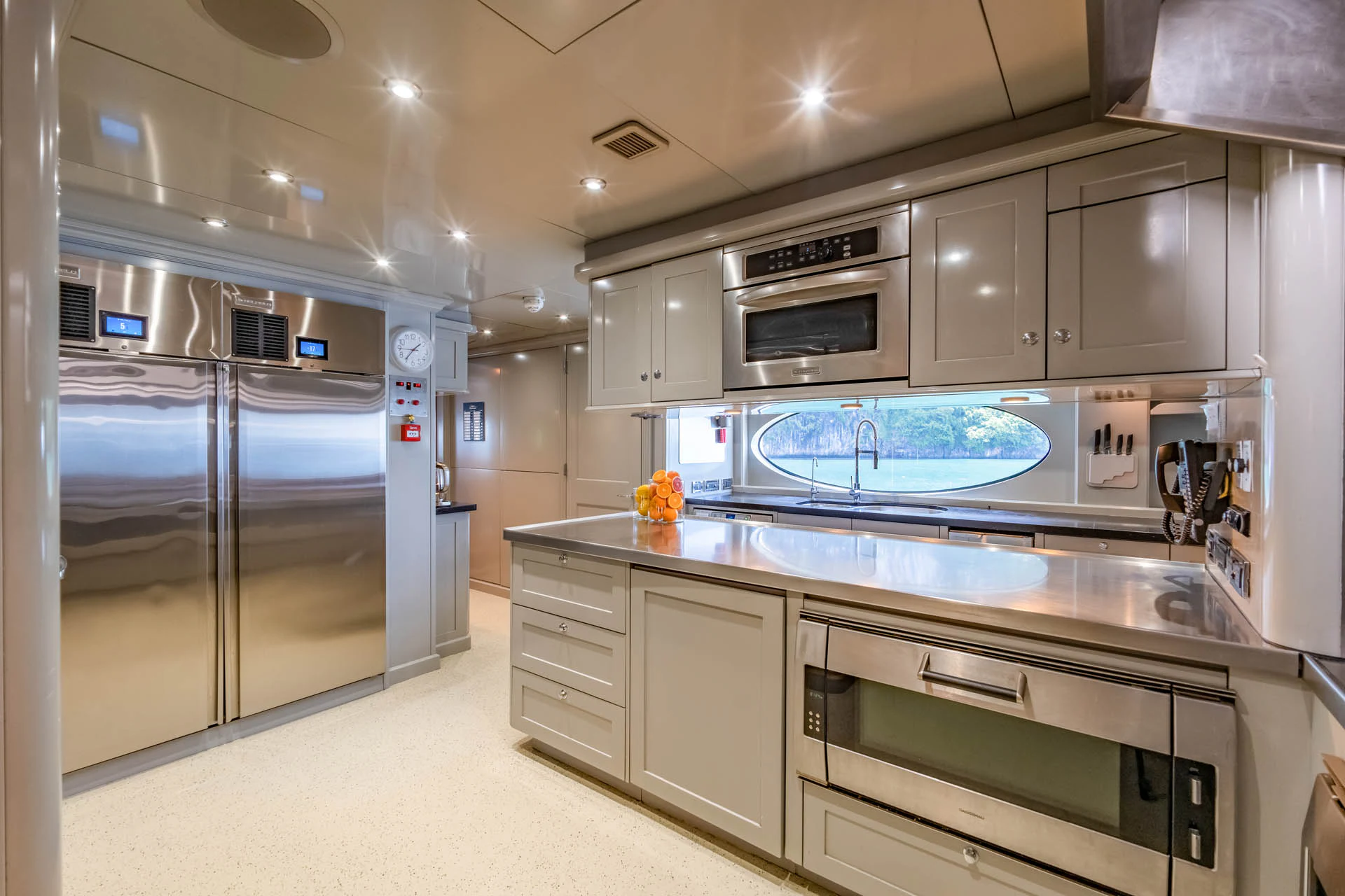 a large kitchen with white cabinets aboard SWEET CAROLINE II Yacht for Sale