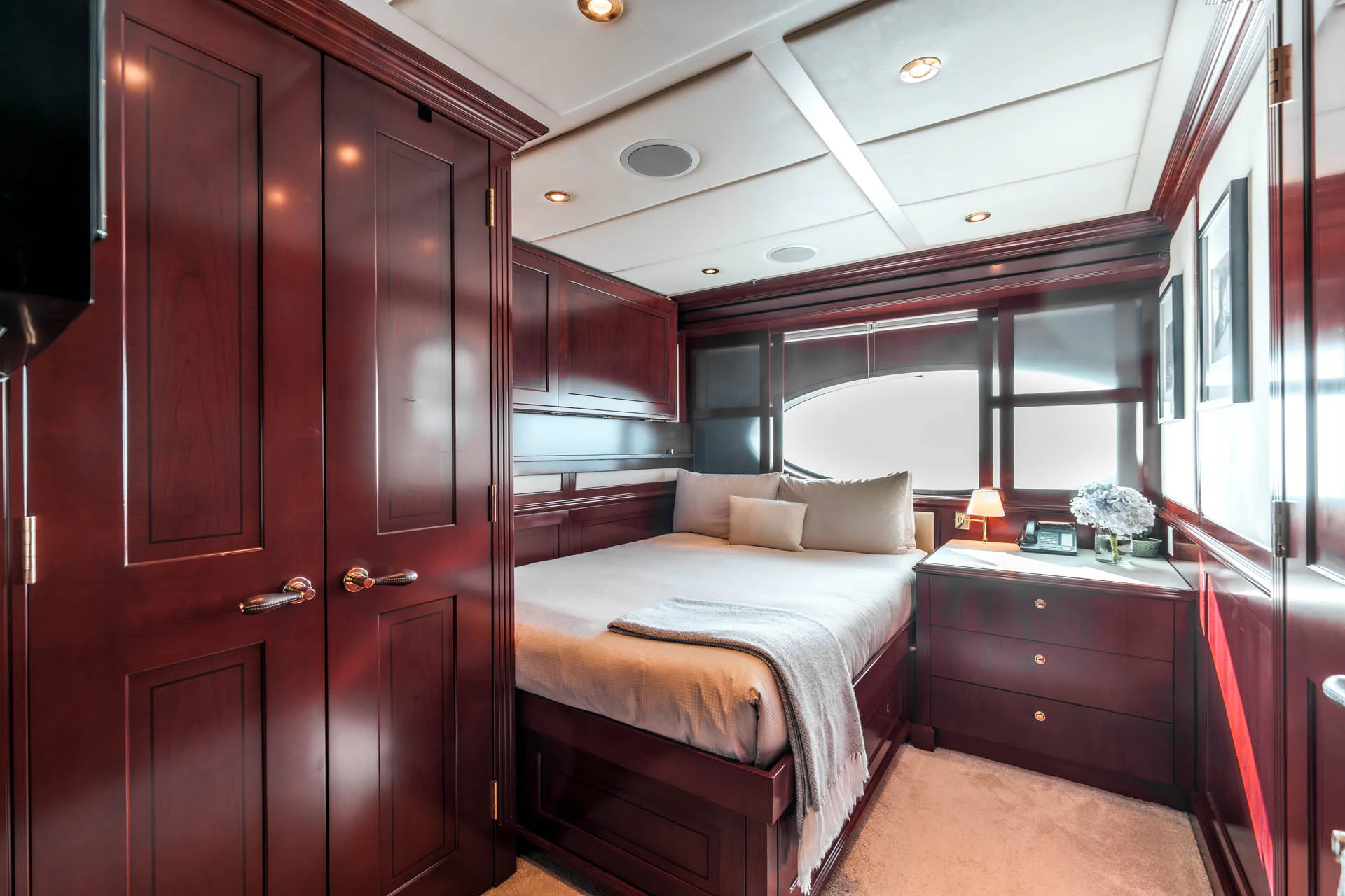 a bedroom with a bed and a closet aboard SWEET CAROLINE II Yacht for Sale