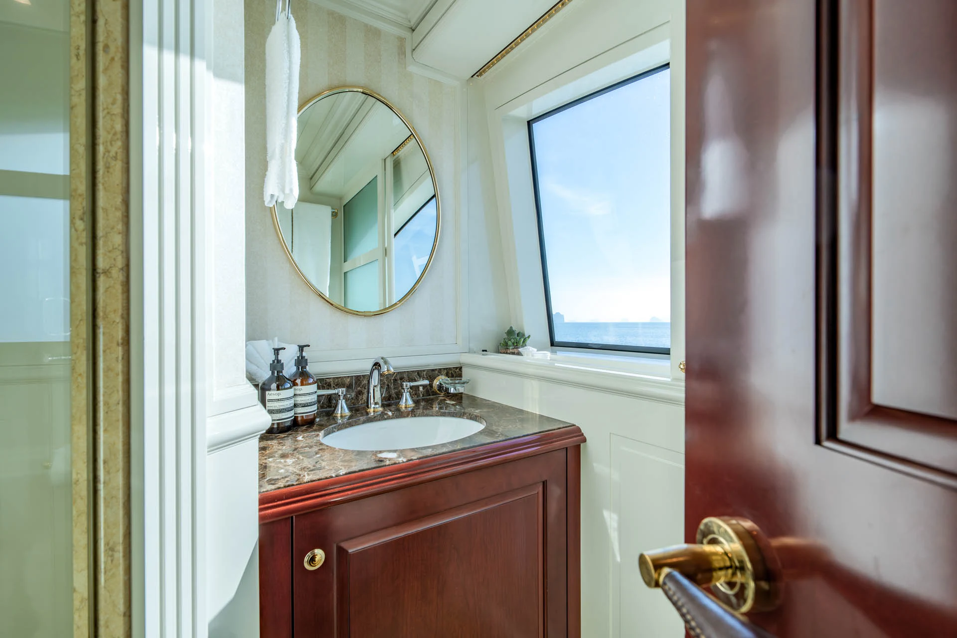 a bathroom with a sink and a mirror aboard SWEET CAROLINE II Yacht for Sale