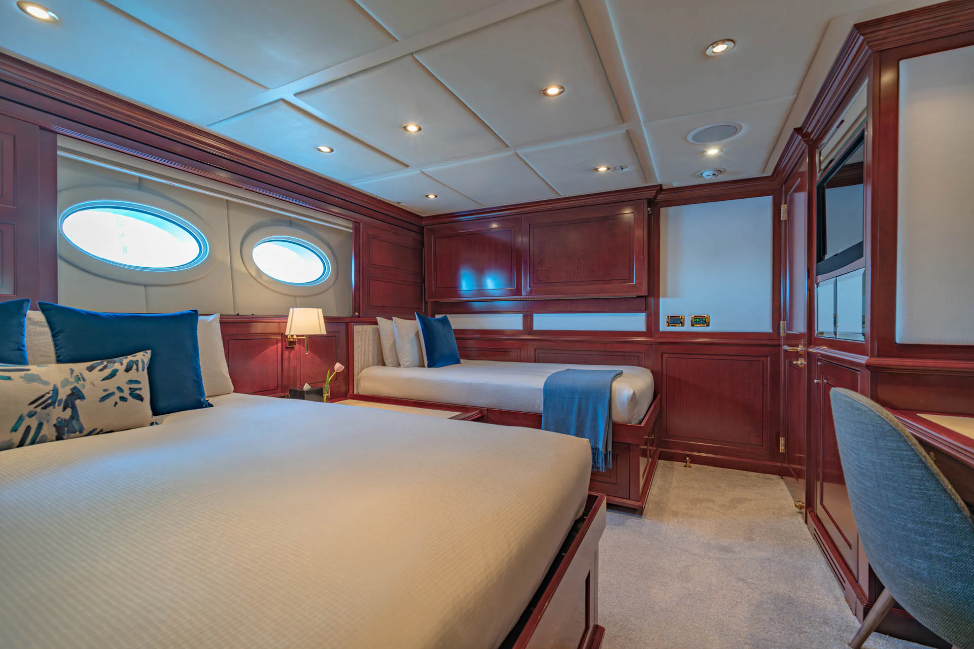a room with a bed and a chair aboard SWEET CAROLINE II Yacht for Sale