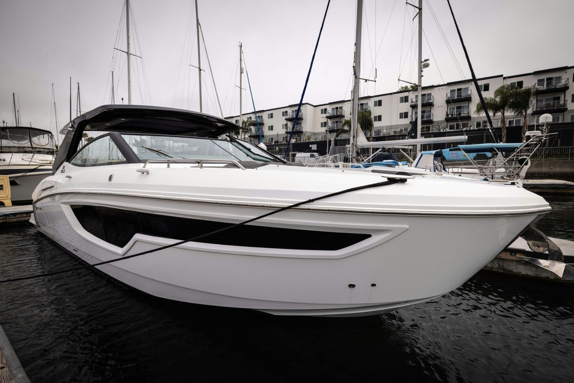 a white boat in a harbor aboard TRUE Yacht for Sale