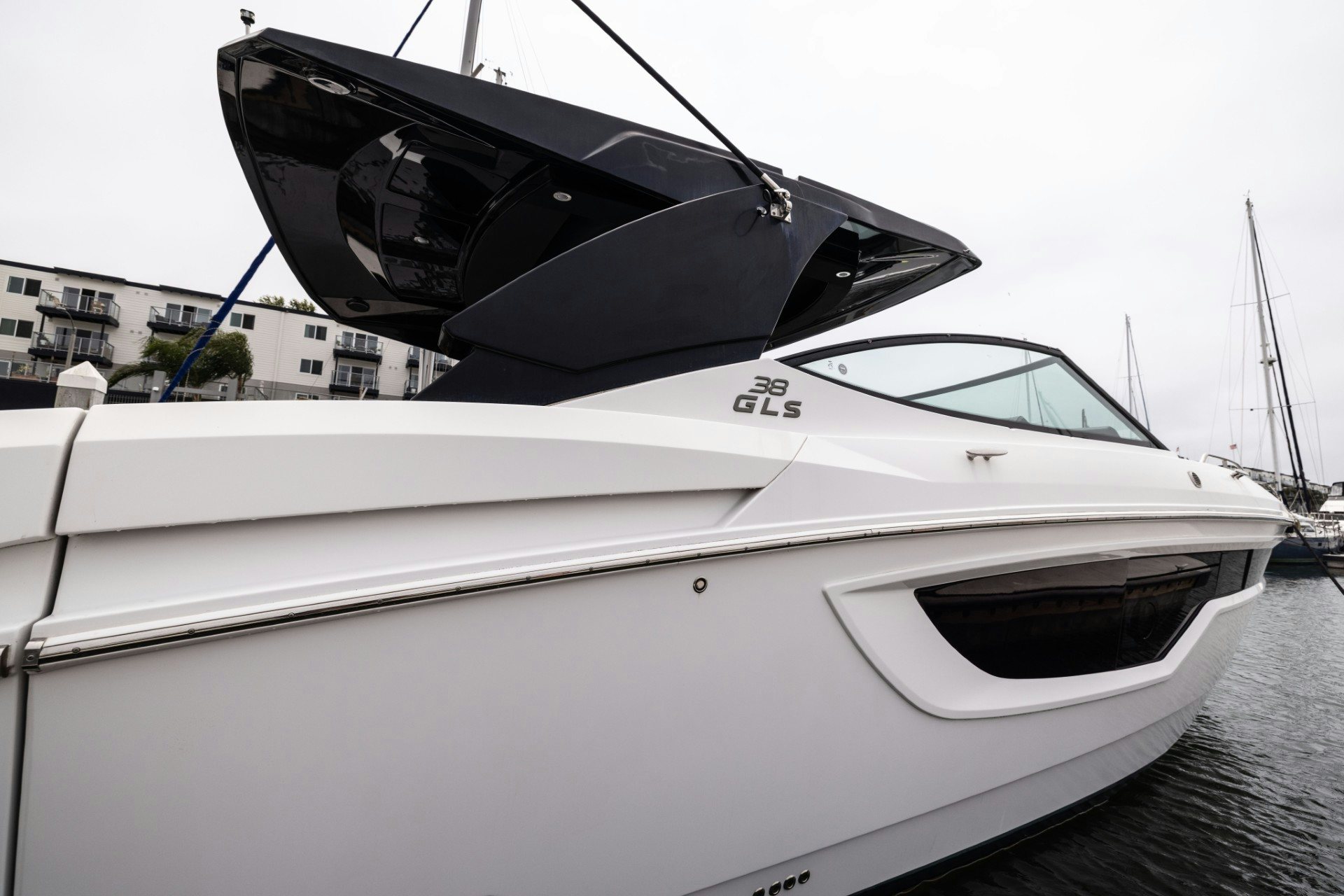 a white boat with a black and white sail aboard TRUE Yacht for Sale