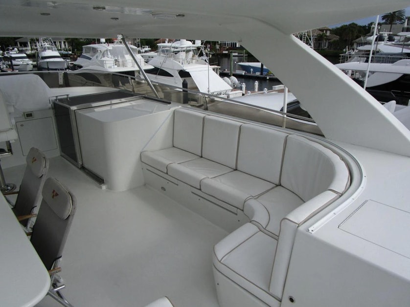a large room with many white chairs aboard FANCIER NANCI Yacht for Sale