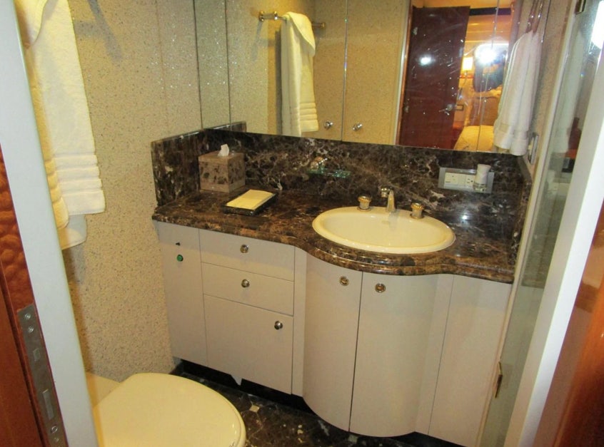 a bathroom with a sink and a mirror aboard FANCIER NANCI Yacht for Sale