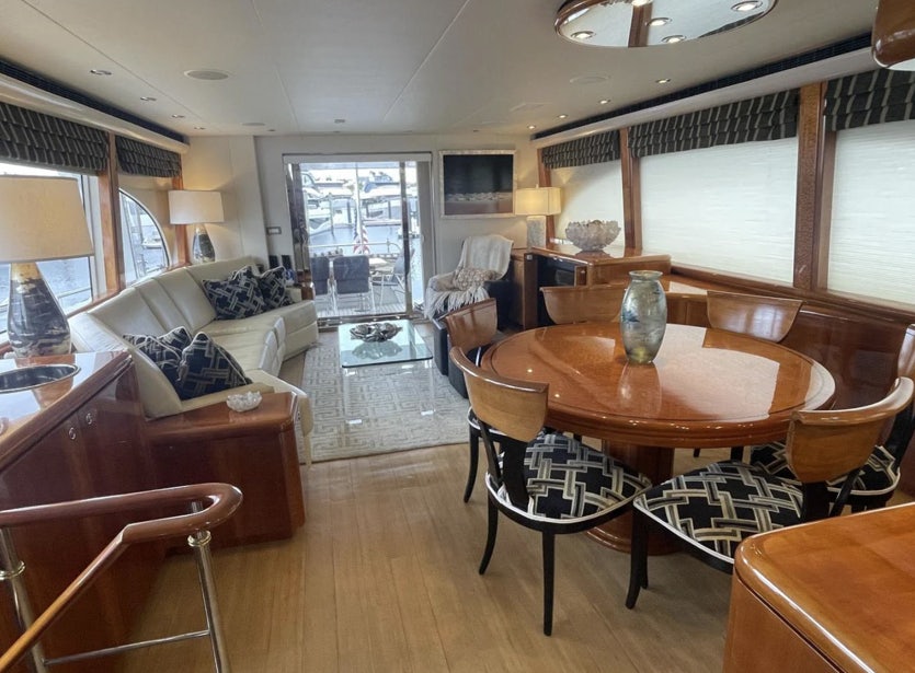 a living room with a table and chairs aboard FANCIER NANCI Yacht for Sale