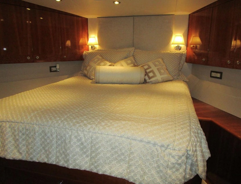 a bed with white sheets aboard FANCIER NANCI Yacht for Sale