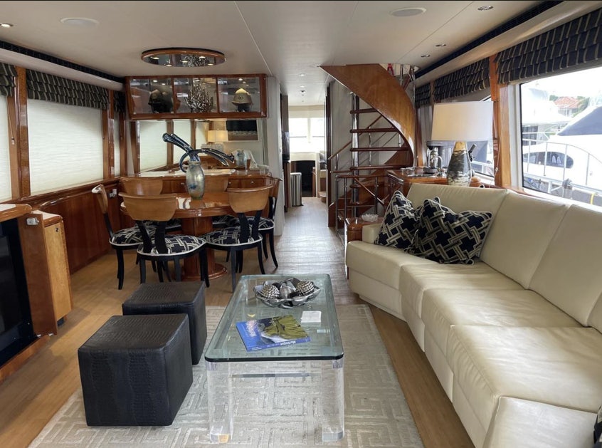 a living room with a couch and a table aboard FANCIER NANCI Yacht for Sale