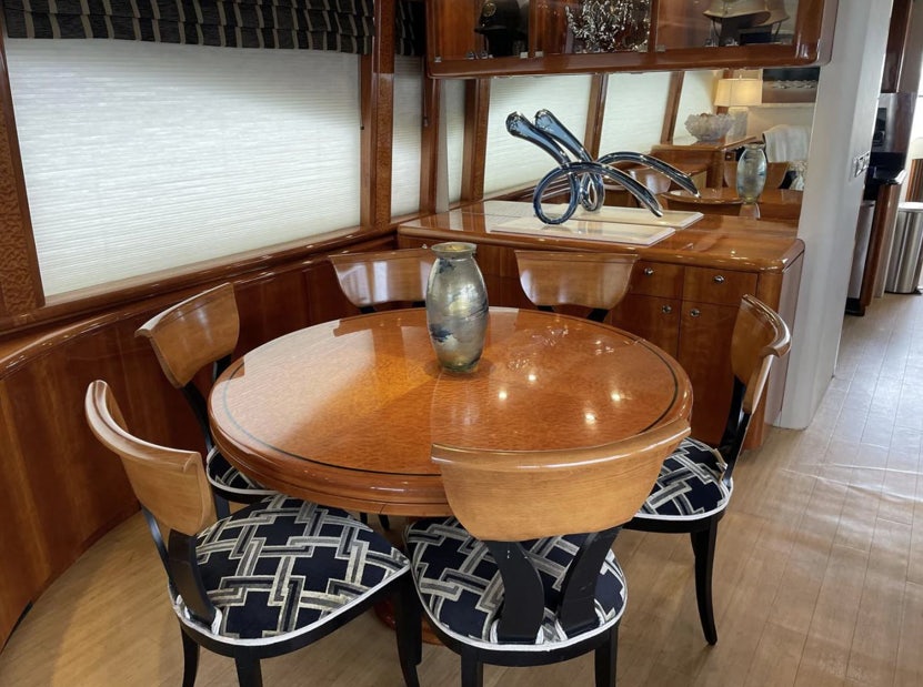 a table with chairs around it aboard FANCIER NANCI Yacht for Sale