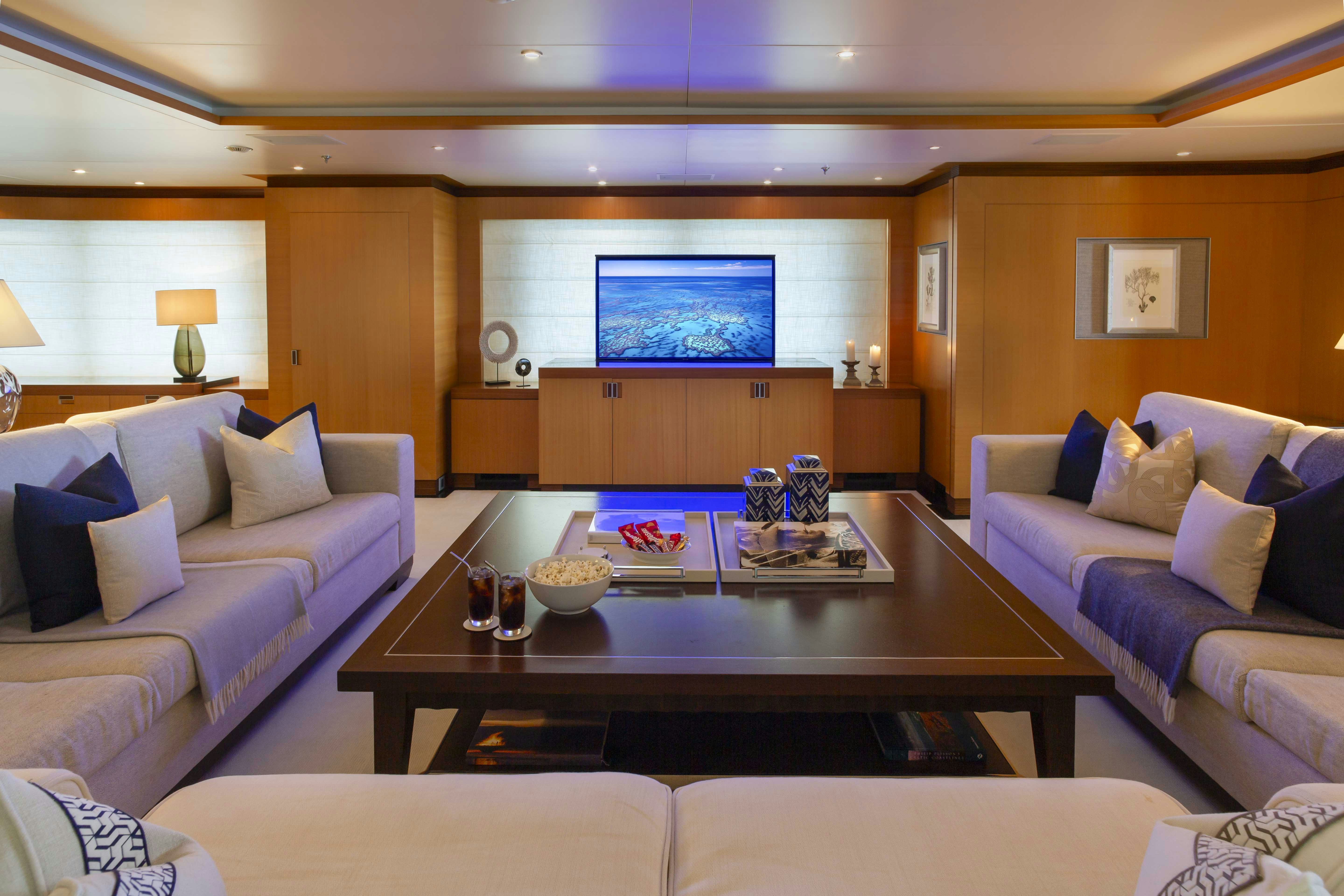 a living room with a table and couches aboard LA BLANCA Yacht for Charter