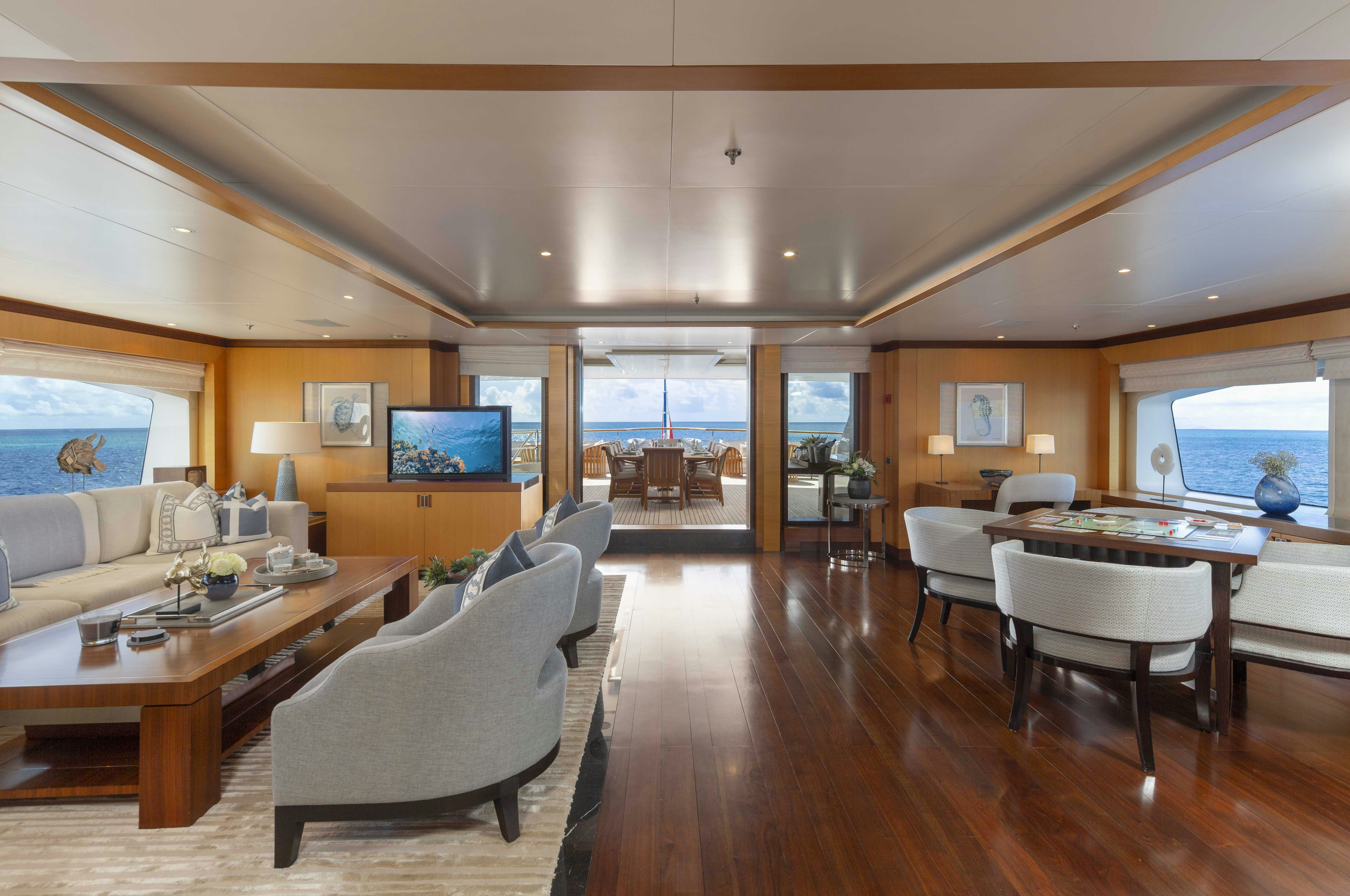 a living room with a wood floor aboard LA BLANCA Yacht for Charter