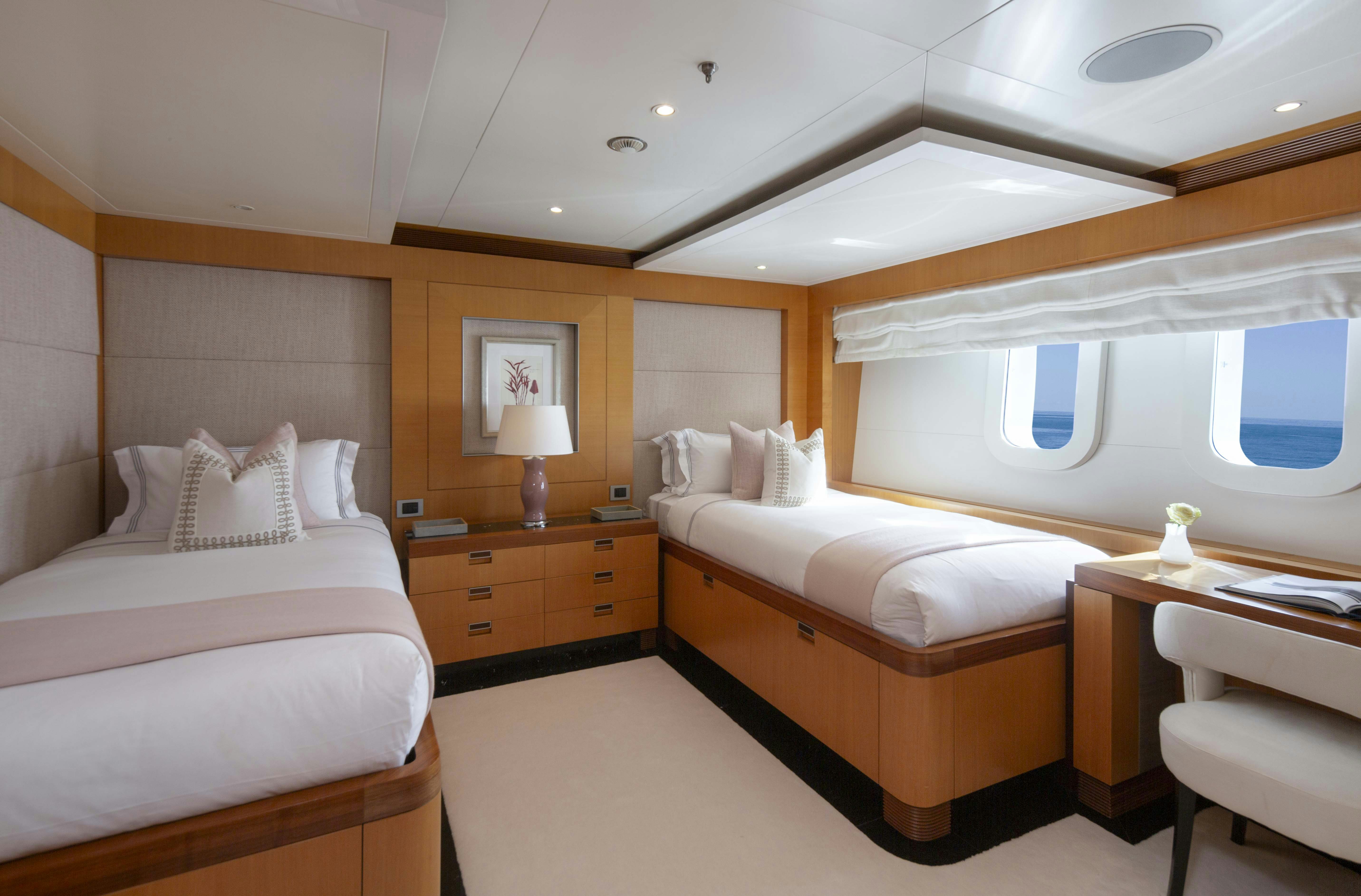 a room with a bed and a window aboard LA BLANCA Yacht for Charter
