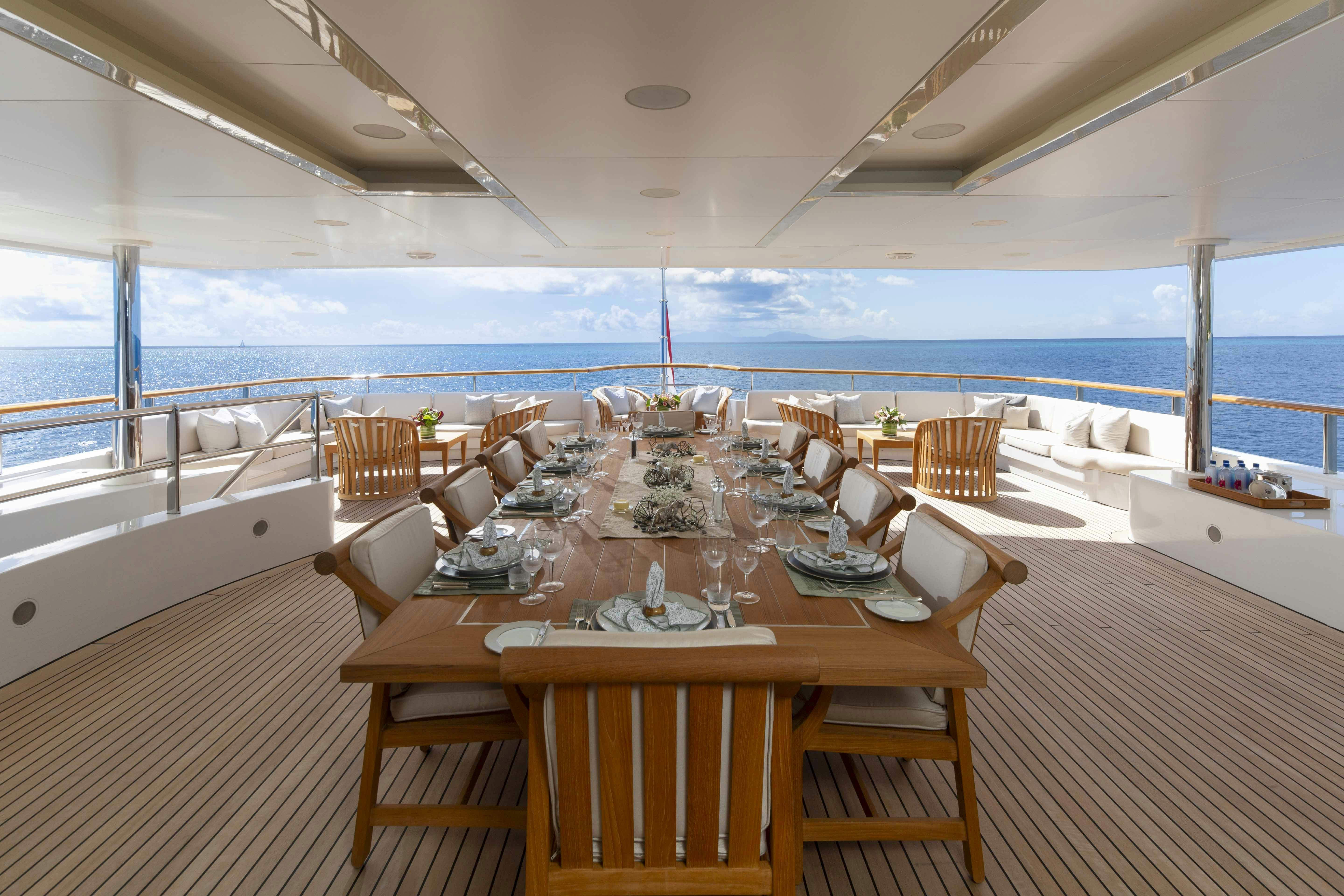a room with a table and chairs aboard LA BLANCA Yacht for Charter
