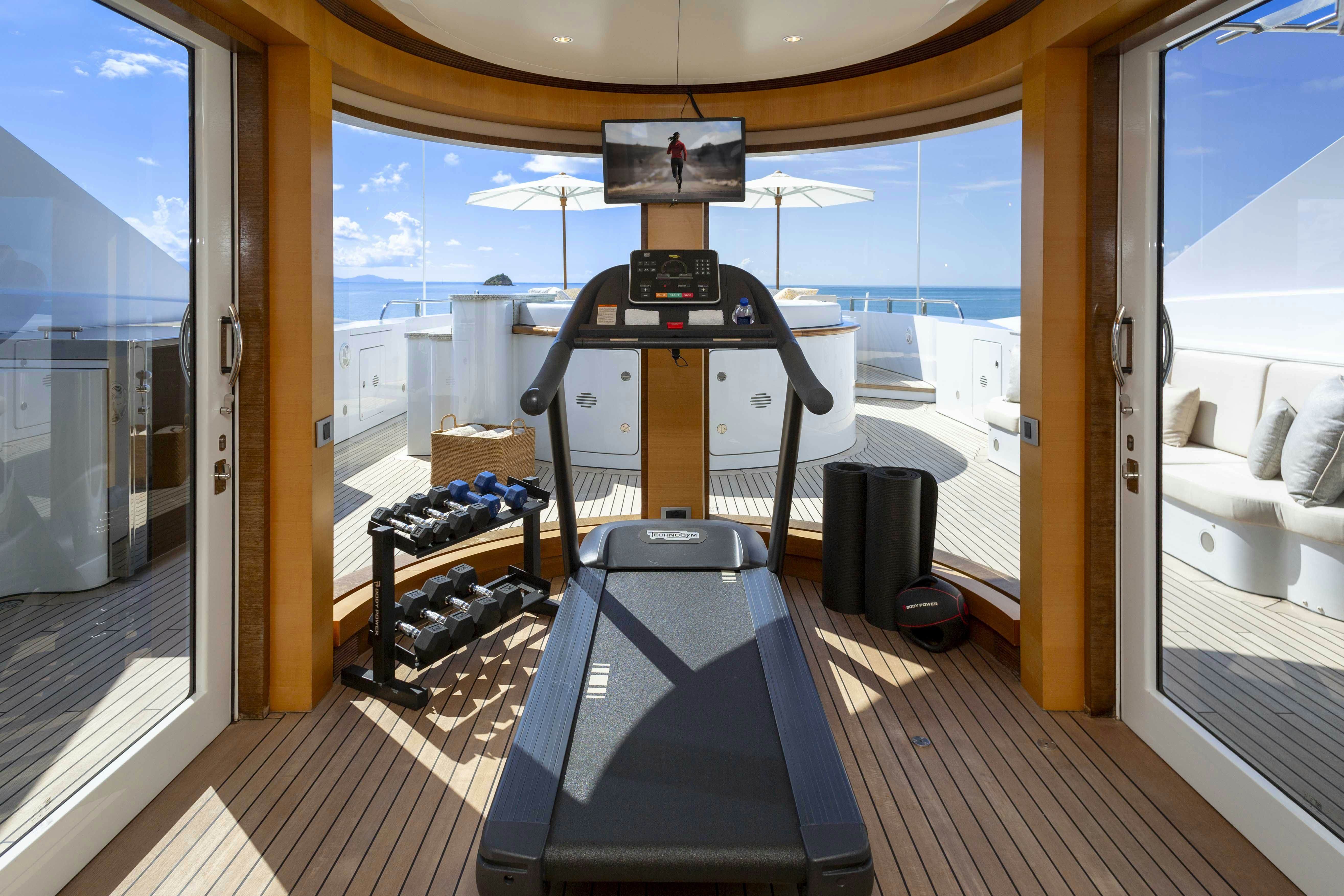 a treadmill in a room aboard LA BLANCA Yacht for Charter