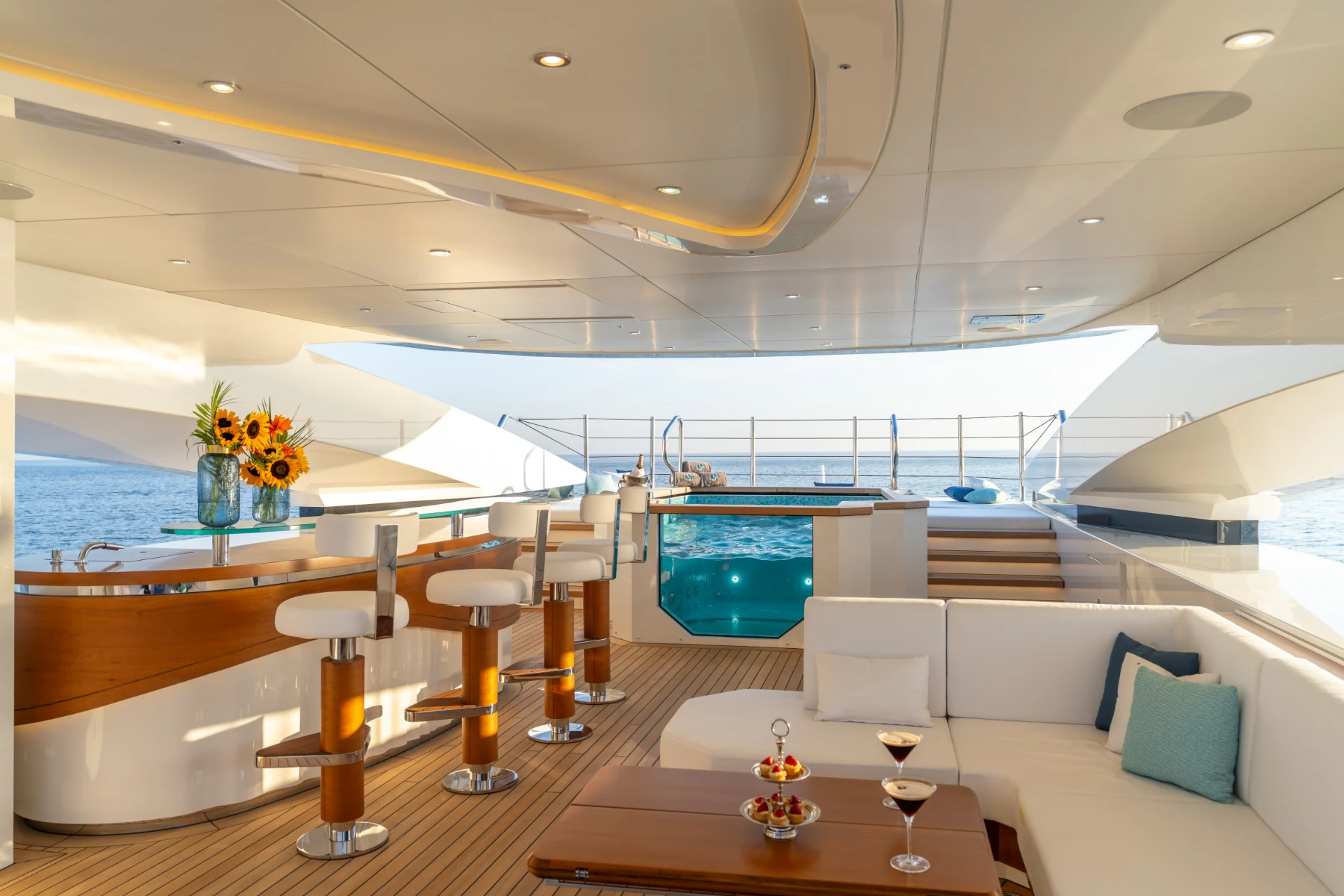 a room with a table and chairs and a pool aboard ETERNAL SPARK Yacht for Charter