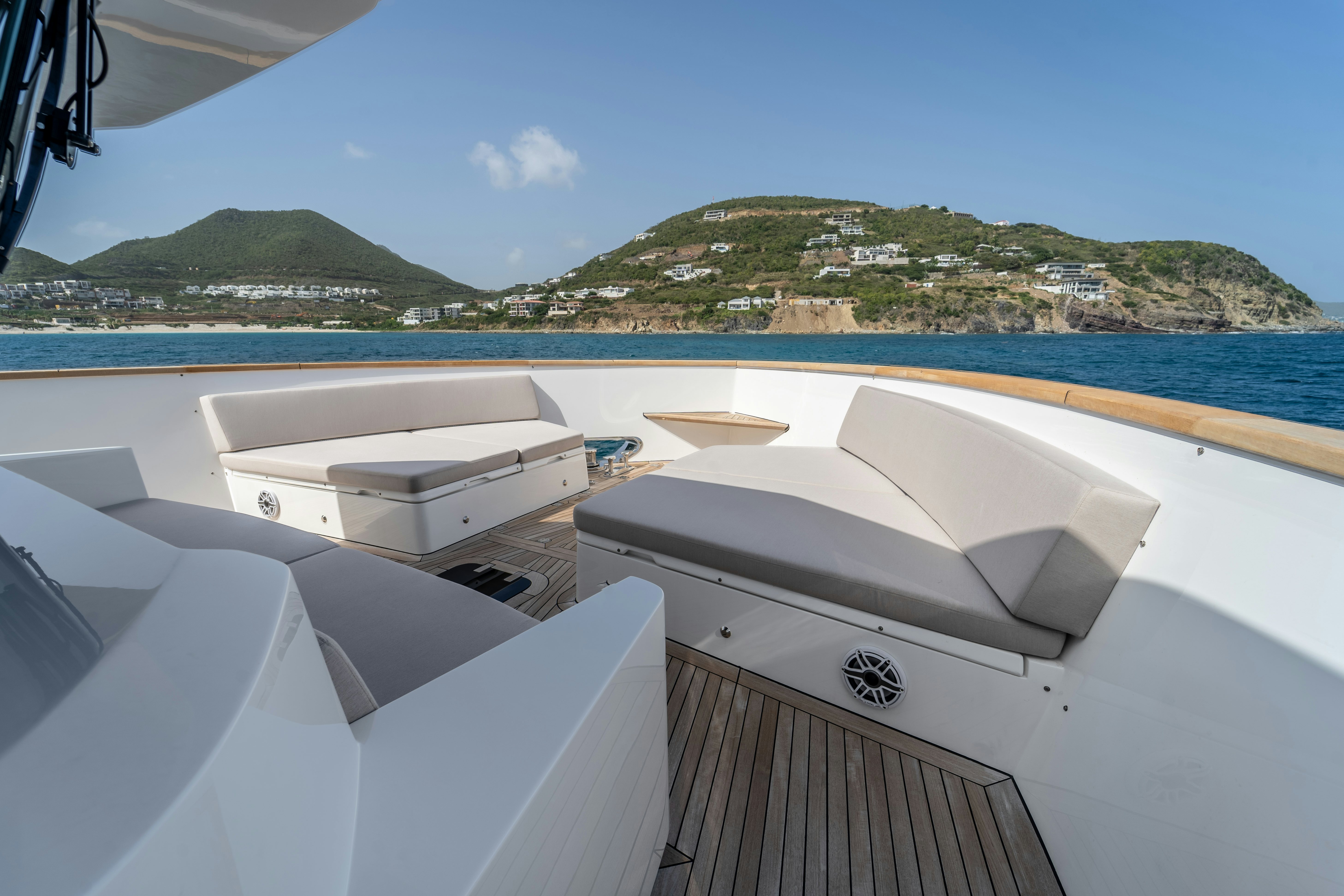 a deck with a view of a beach and a city aboard EXIT STRATEGY Yacht for Sale