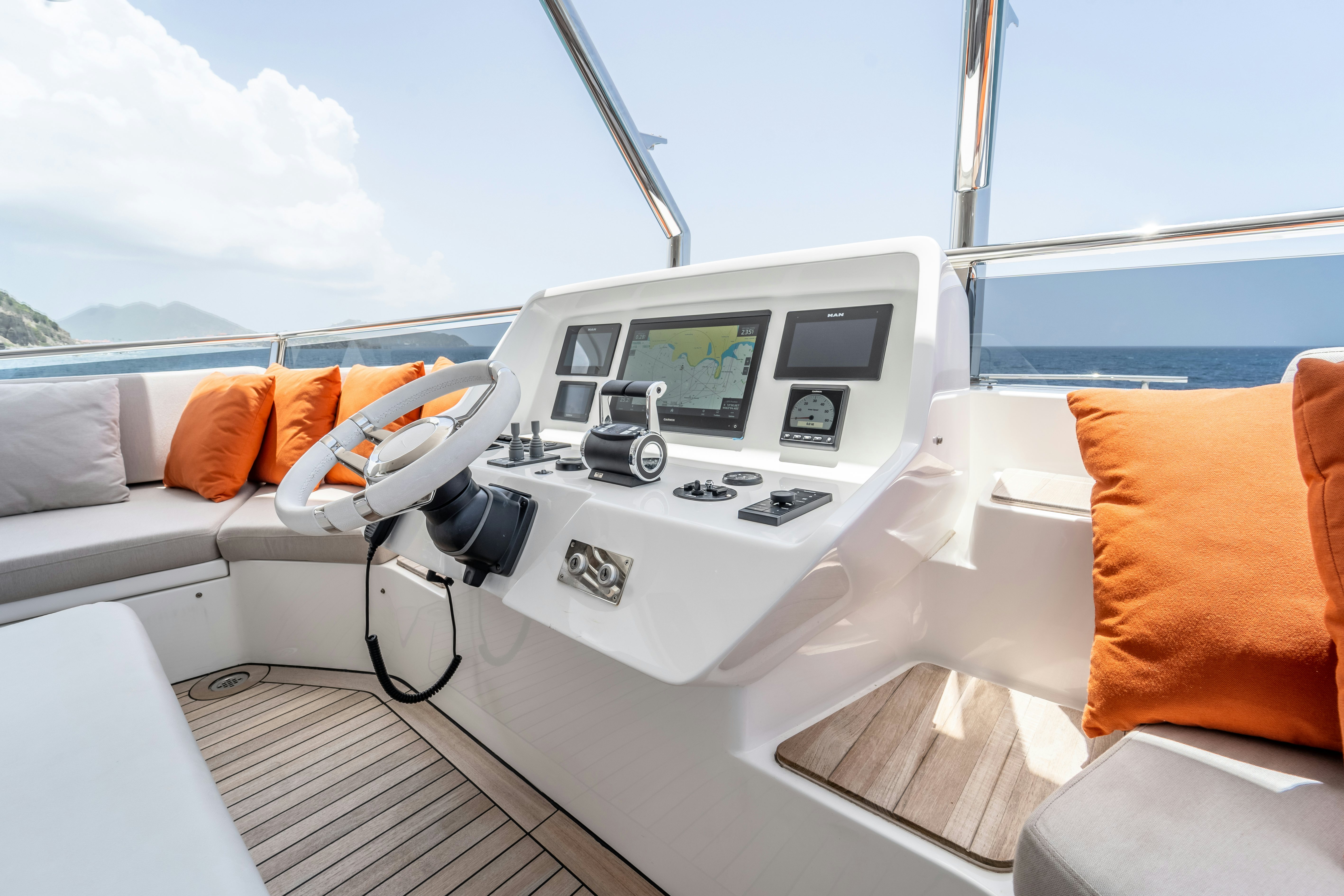 a white yacht with a screen and orange pillows on the deck aboard EXIT STRATEGY Yacht for Sale