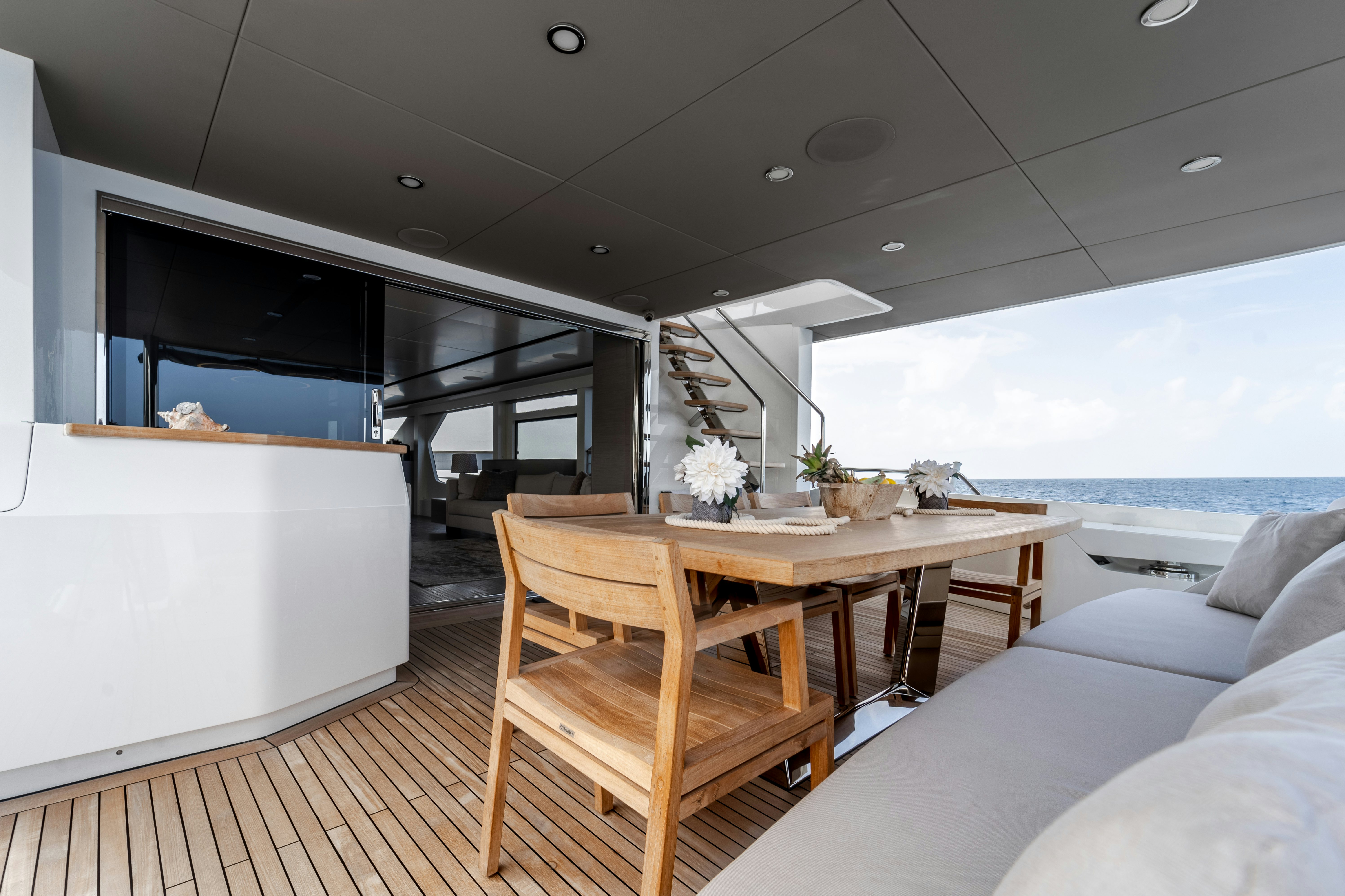 a room with a table and couch aboard EXIT STRATEGY Yacht for Sale