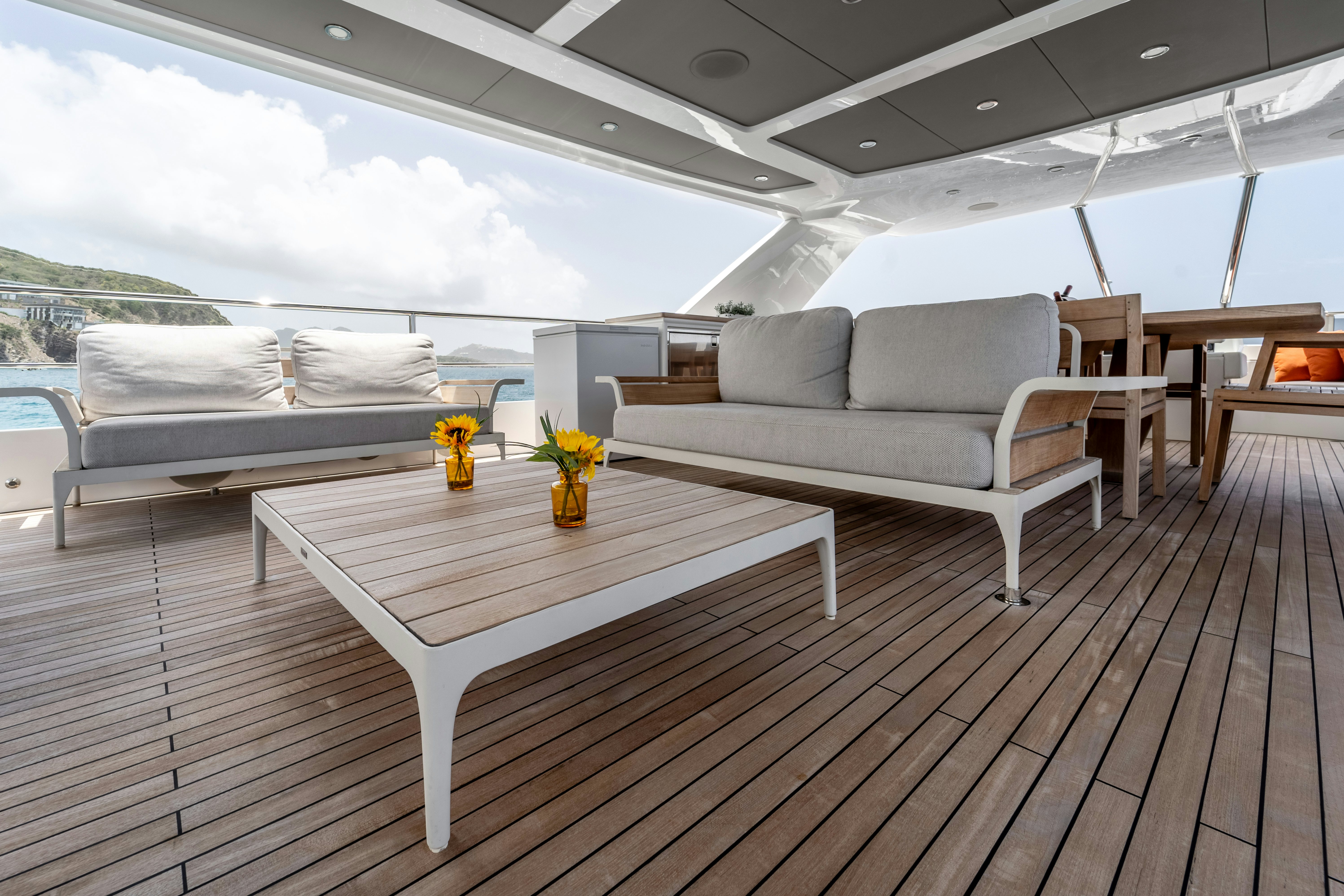 a room with a table and couches aboard EXIT STRATEGY Yacht for Sale
