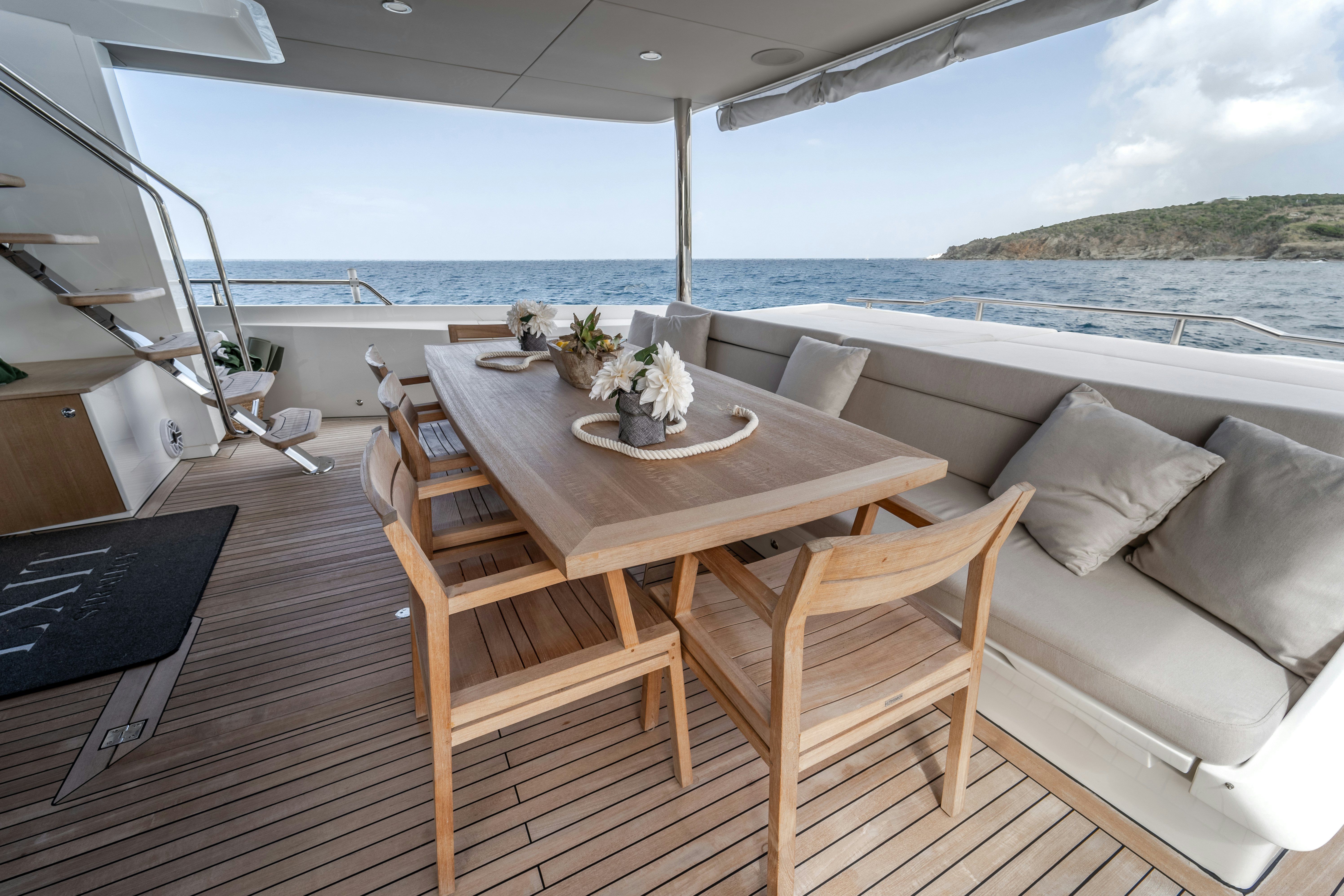 a table on a deck overlooking the ocean aboard EXIT STRATEGY Yacht for Sale