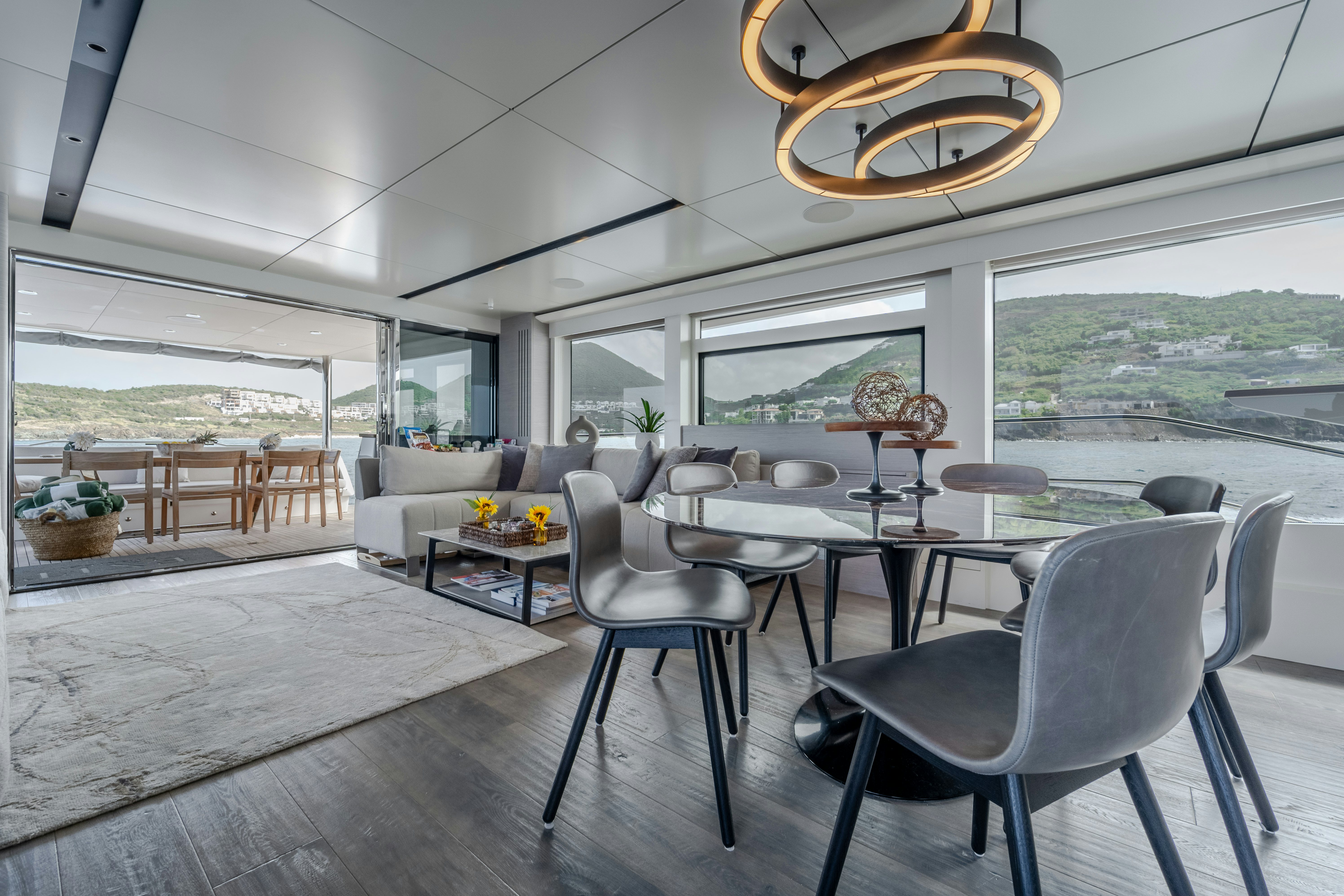 a room with a table chairs and a large window aboard EXIT STRATEGY Yacht for Sale