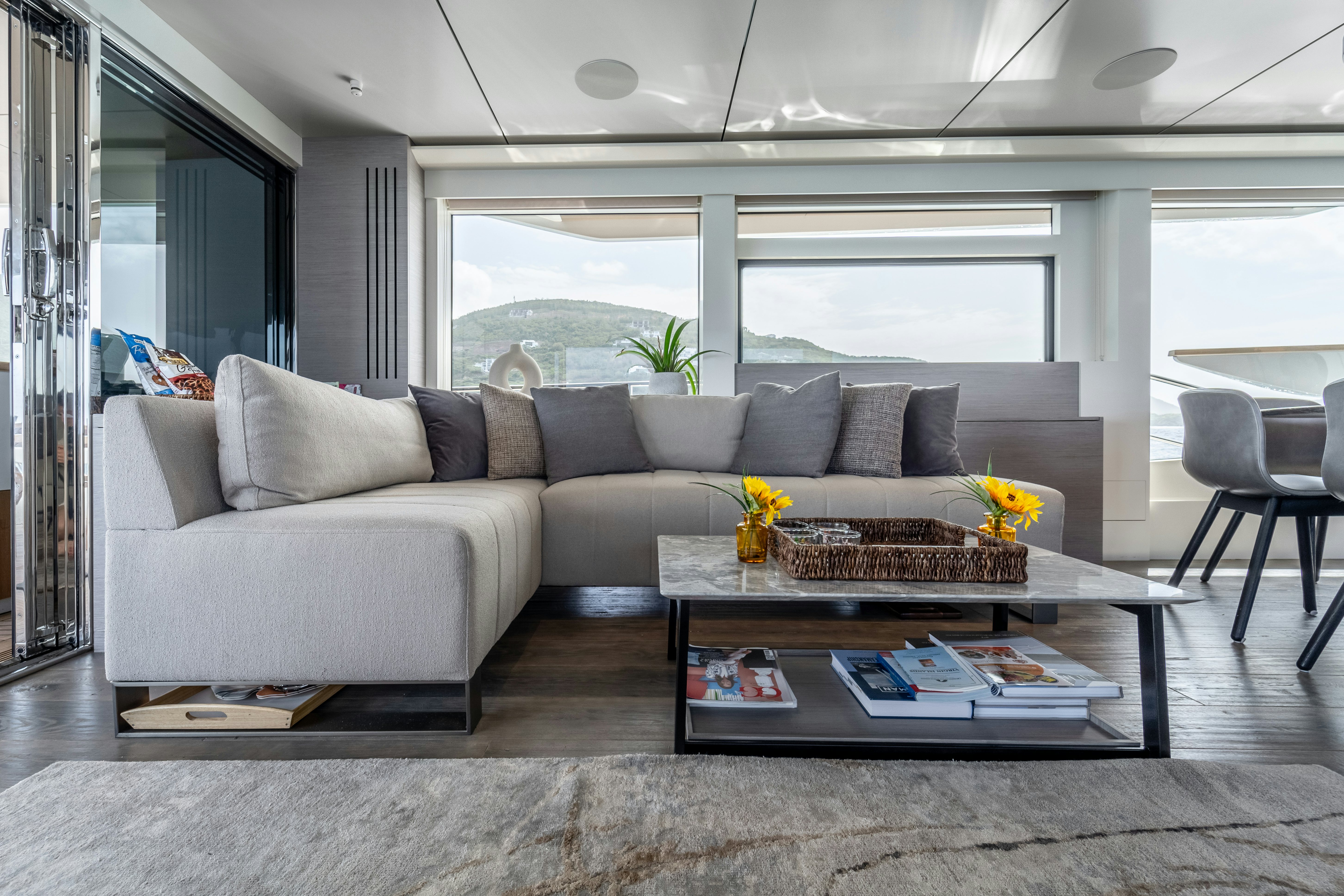 a living room with a couch and coffee table aboard EXIT STRATEGY Yacht for Sale