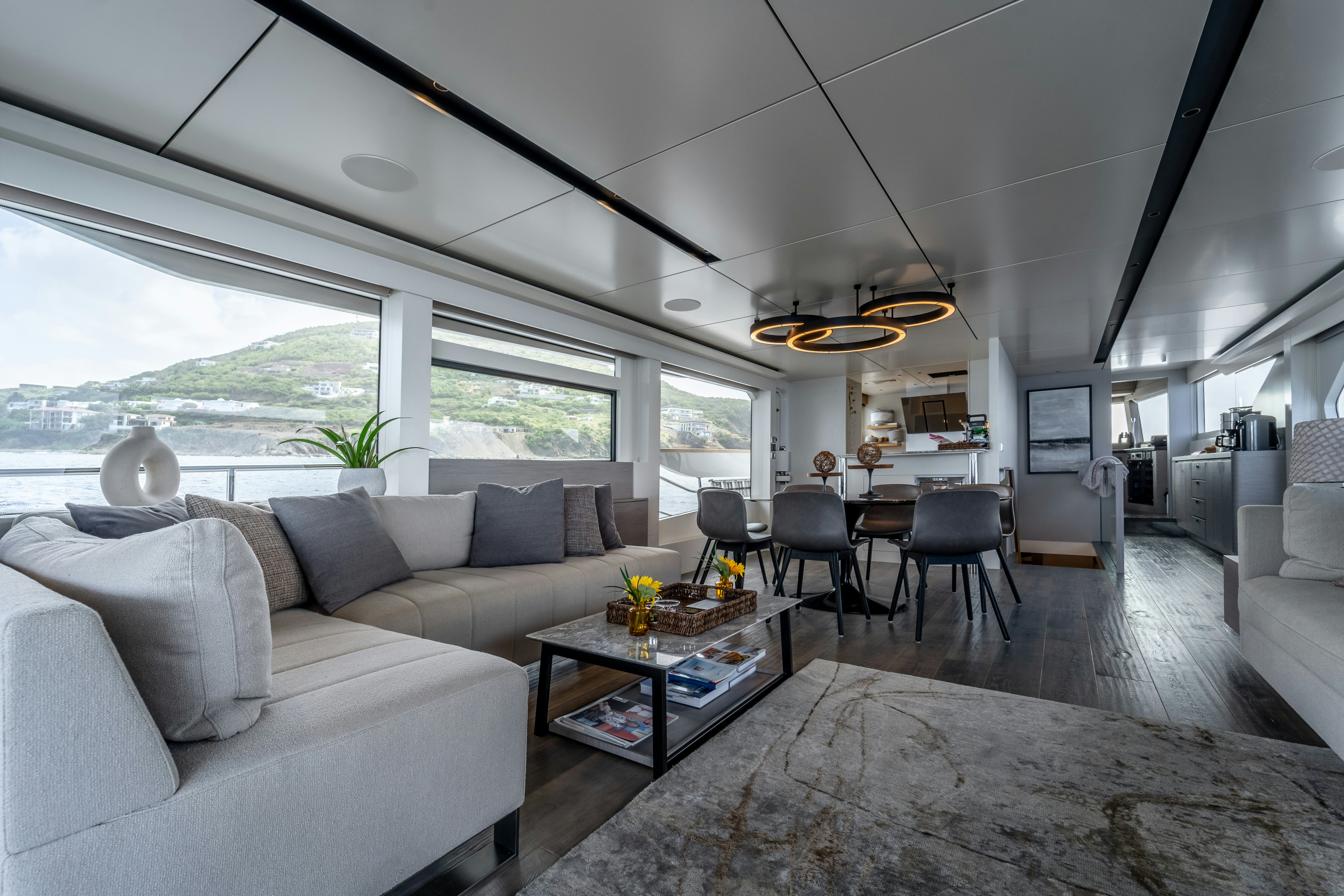 a living room with a couch and a coffee table aboard EXIT STRATEGY Yacht for Sale