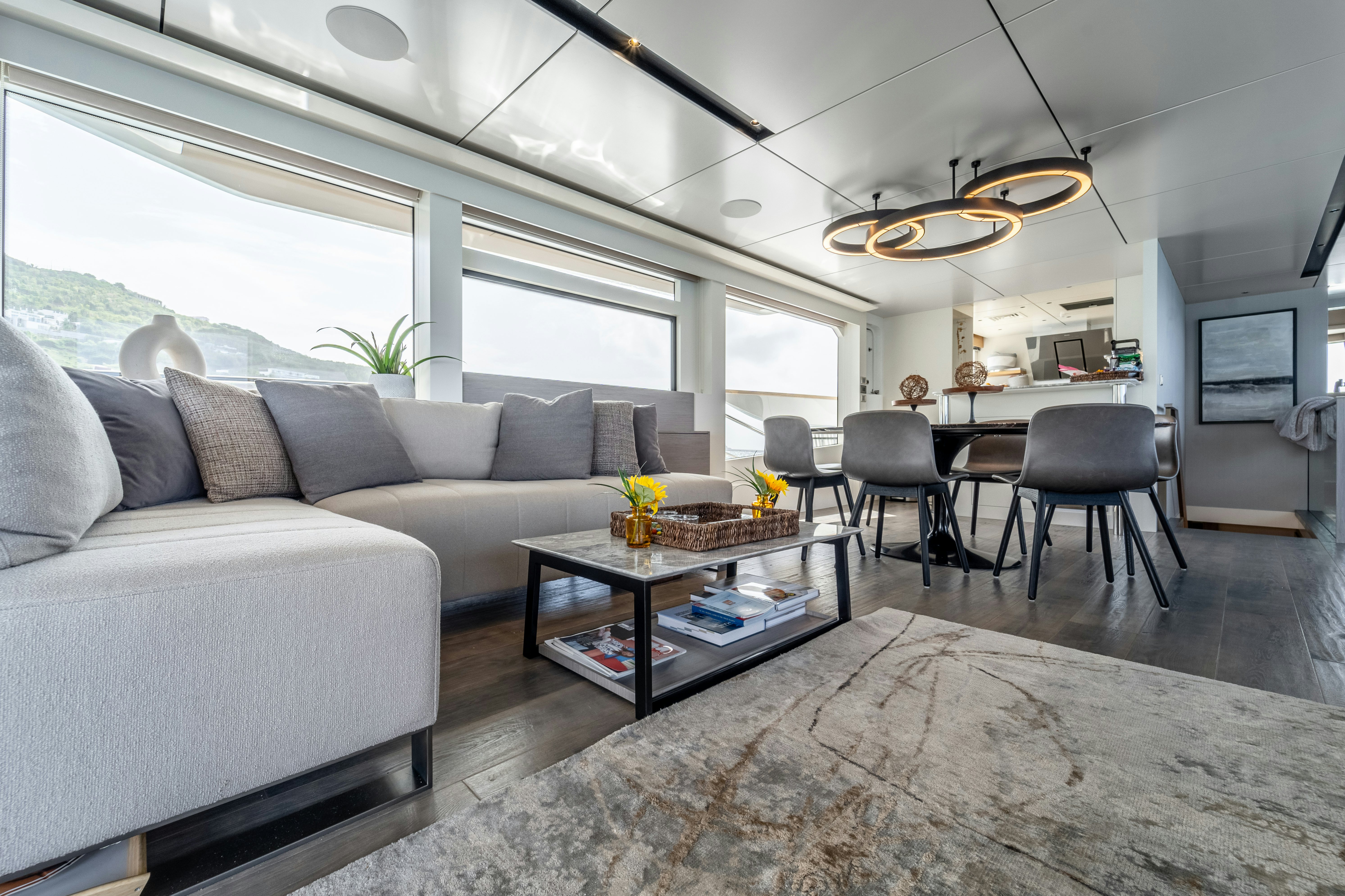 a living room with a couch and a coffee table aboard EXIT STRATEGY Yacht for Sale
