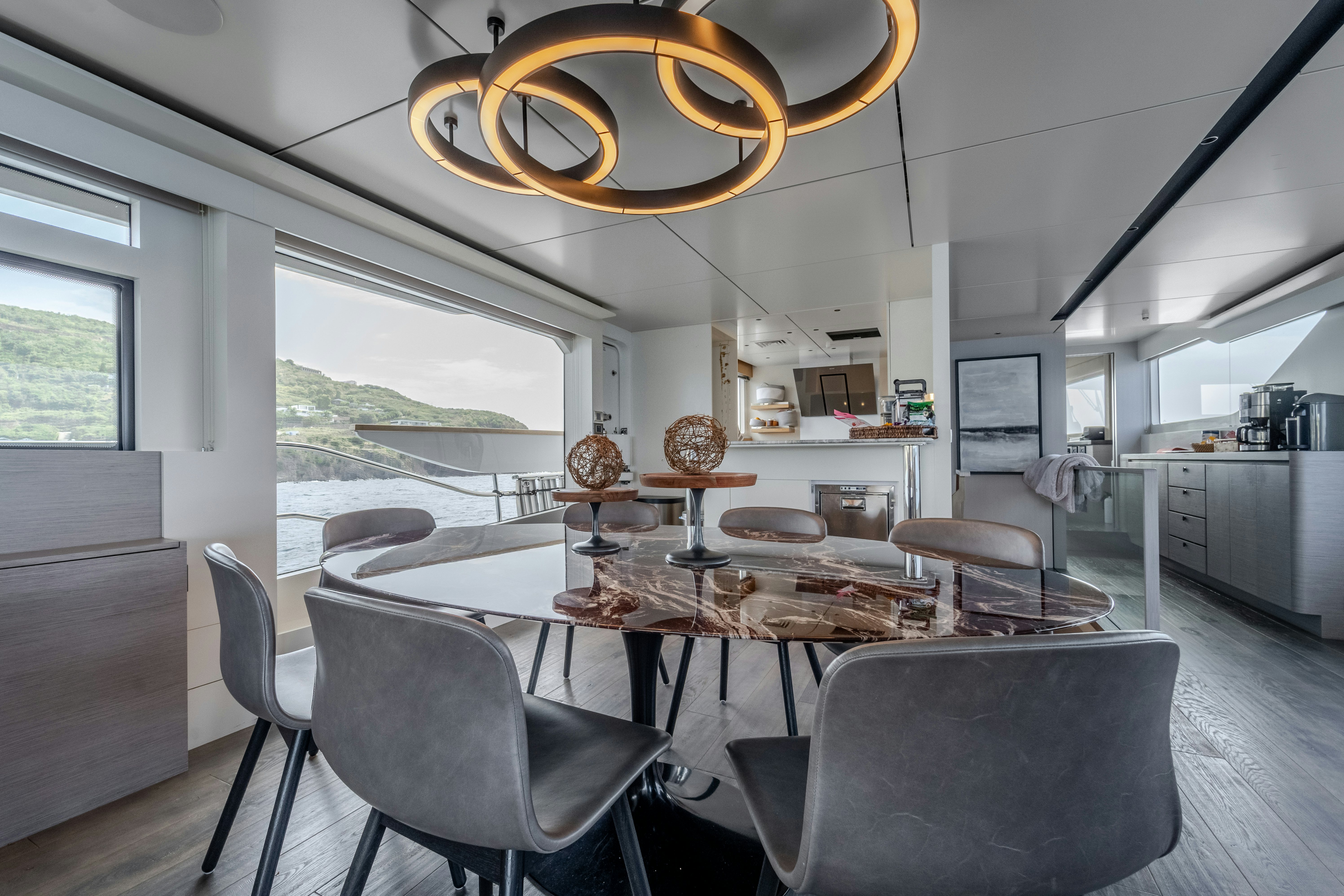 a kitchen with a dining table aboard EXIT STRATEGY Yacht for Sale
