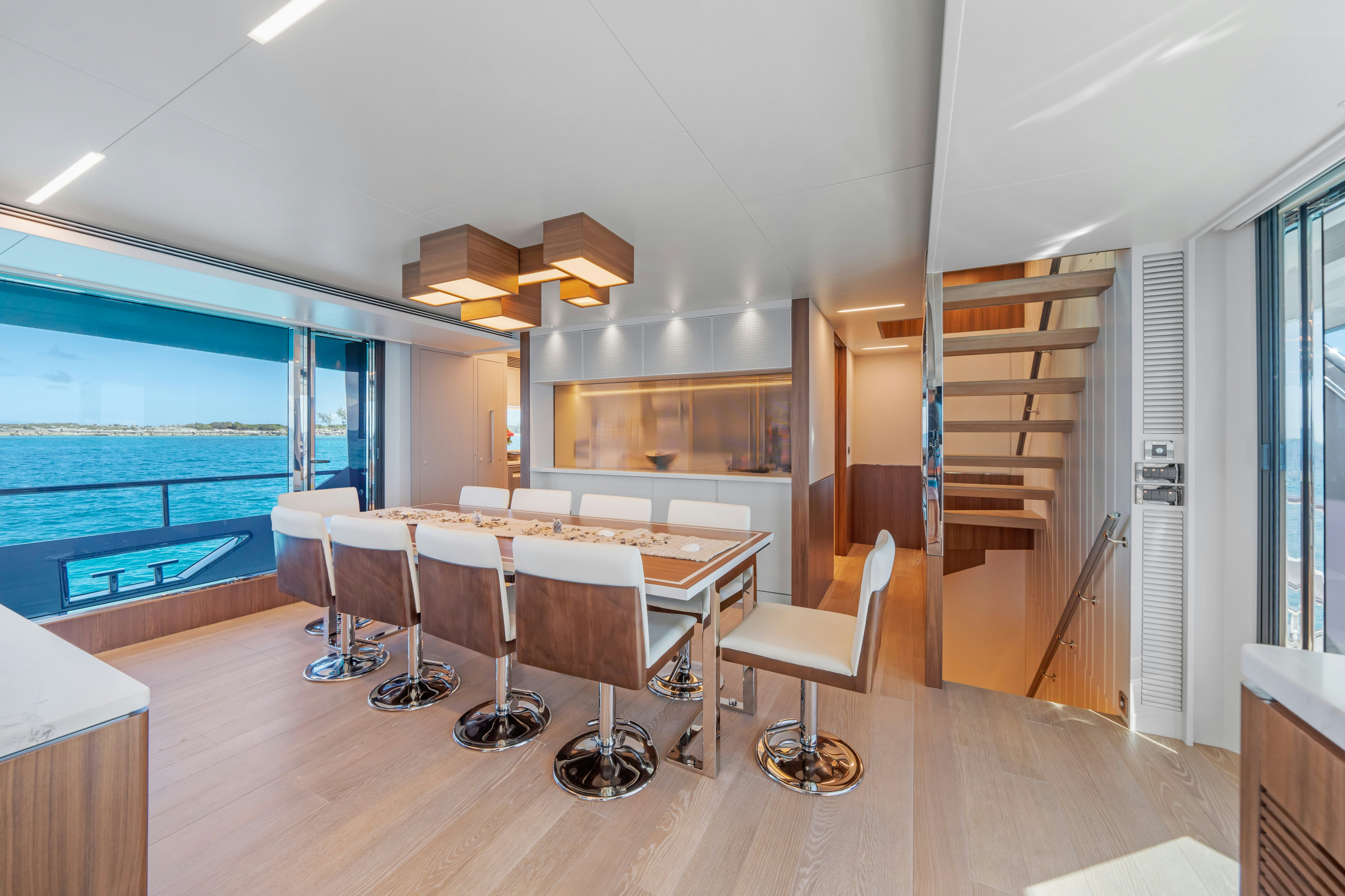 a room with a table chairs and a window aboard RIO Yacht for Sale