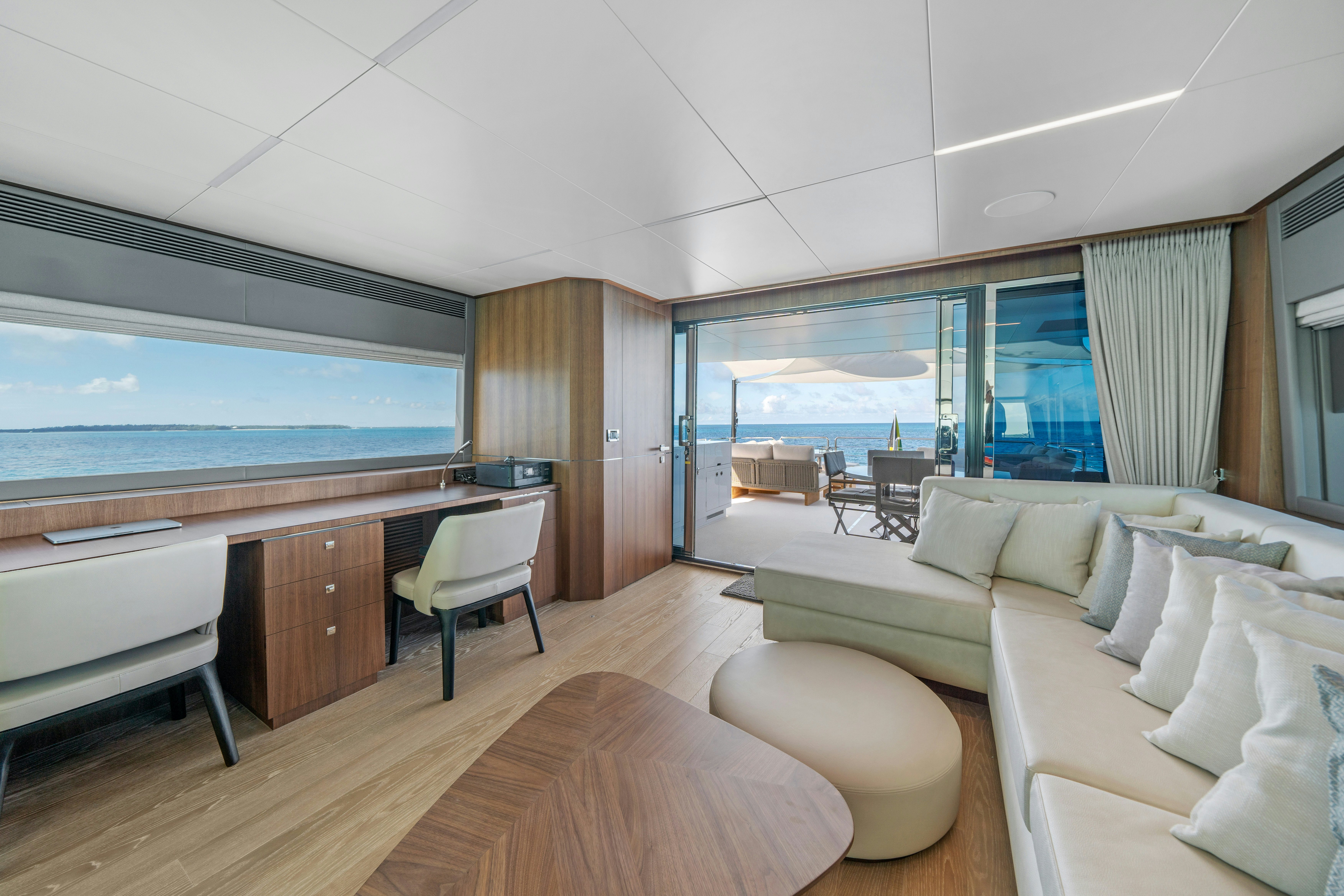 a room with a couch and a table and a tv aboard RIO Yacht for Sale