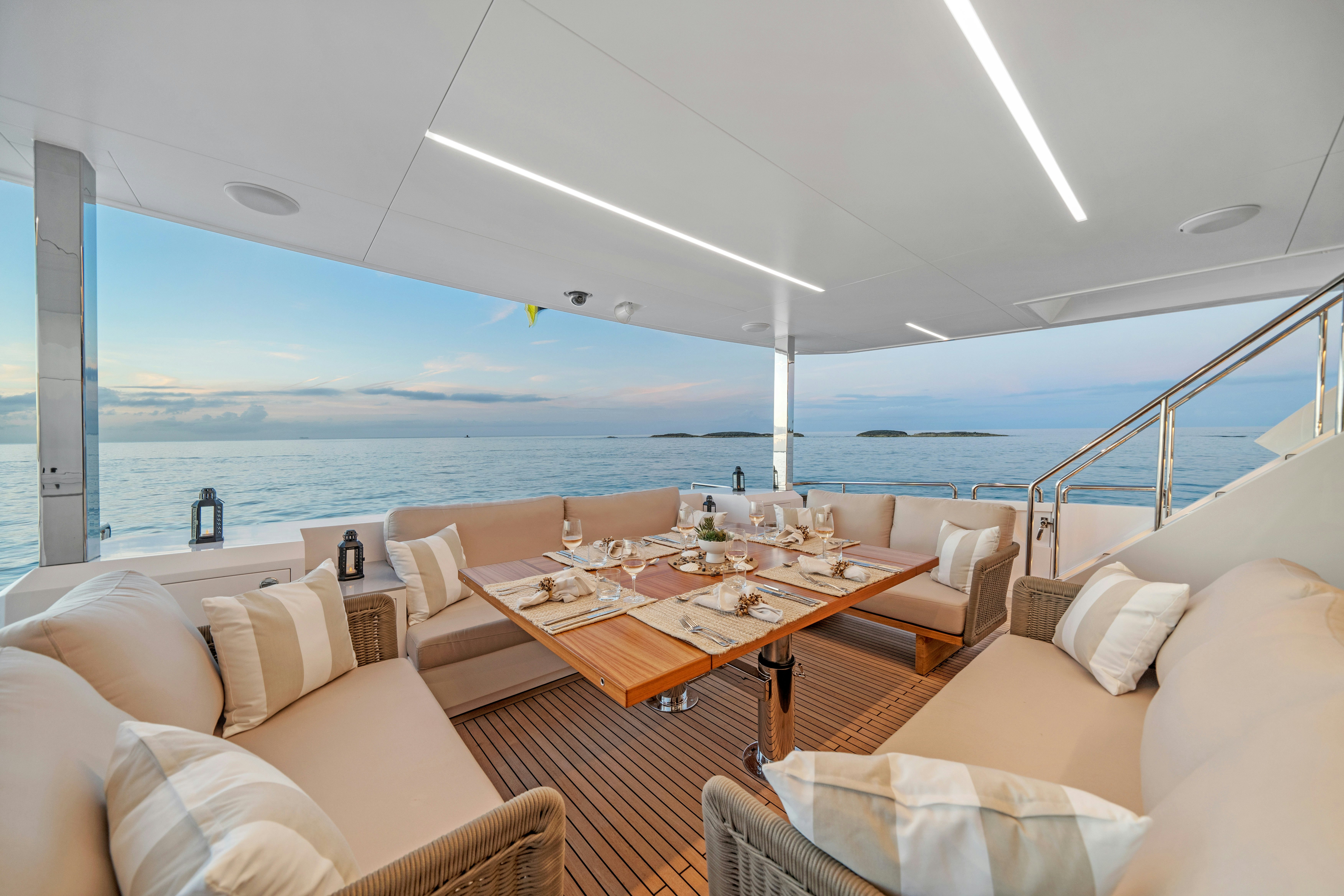 a room with a table chairs and a view of the ocean aboard RIO Yacht for Sale