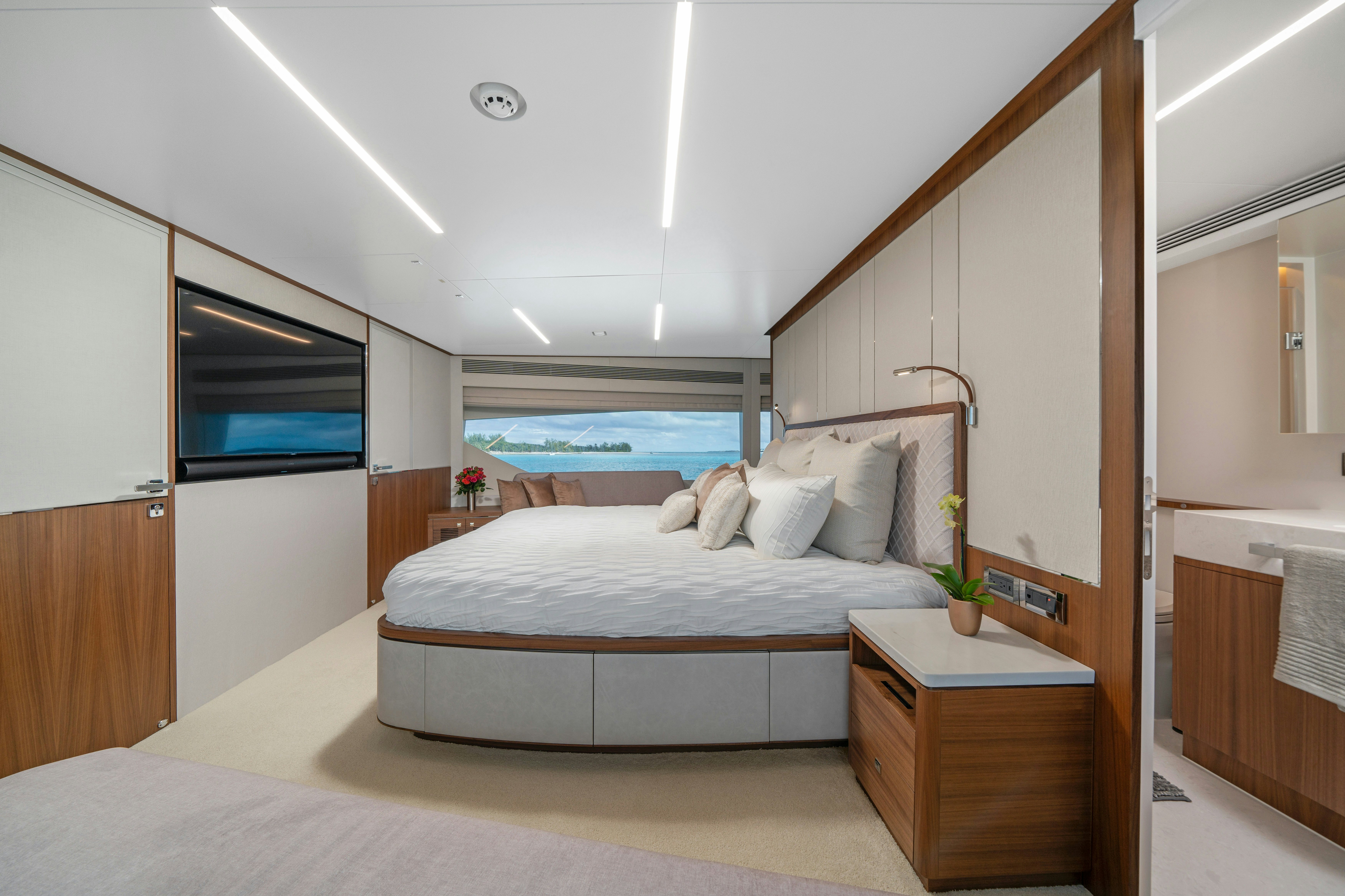 a bedroom with a bed and a window aboard RIO Yacht for Sale