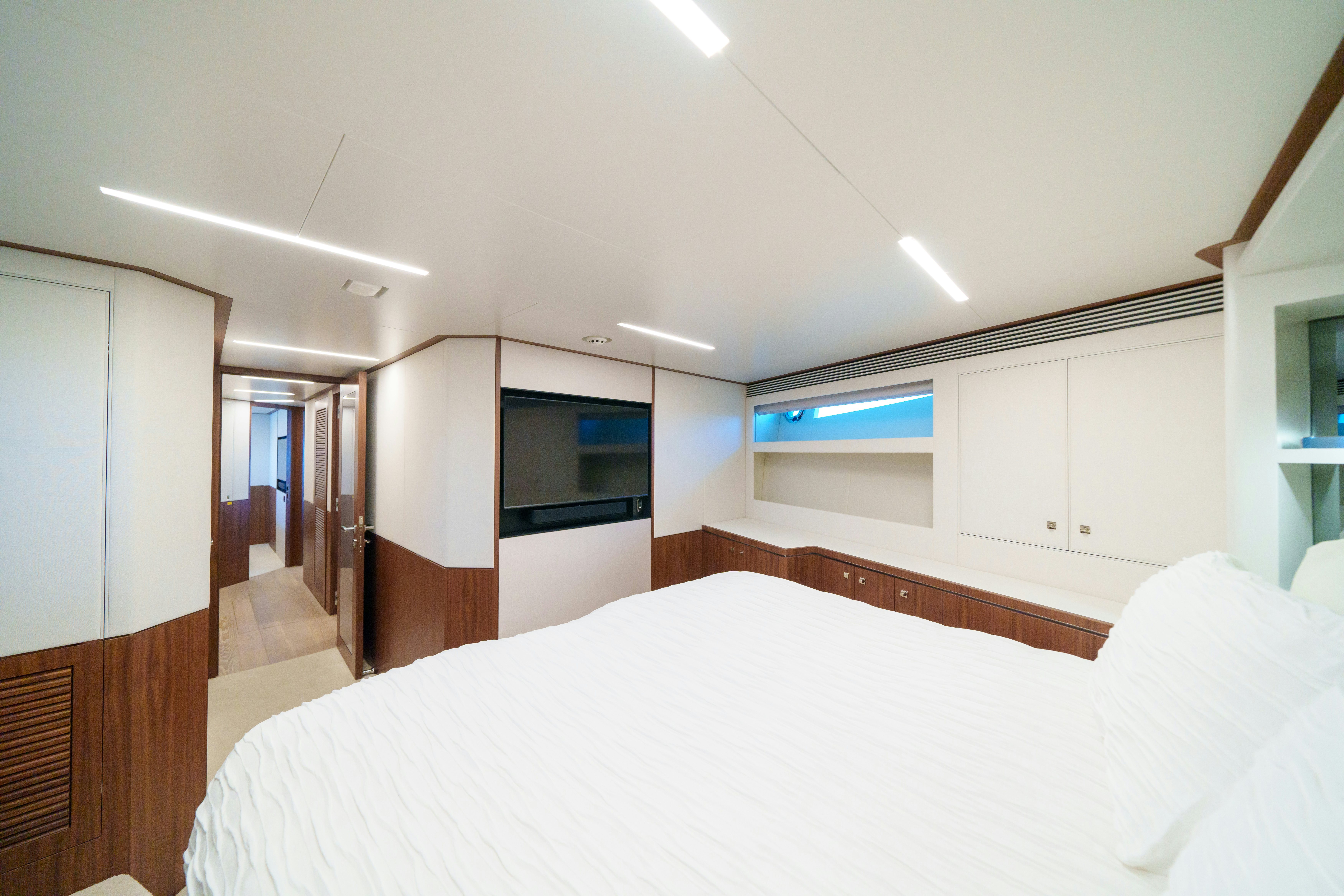 a bedroom with a bed and a television aboard RIO Yacht for Sale