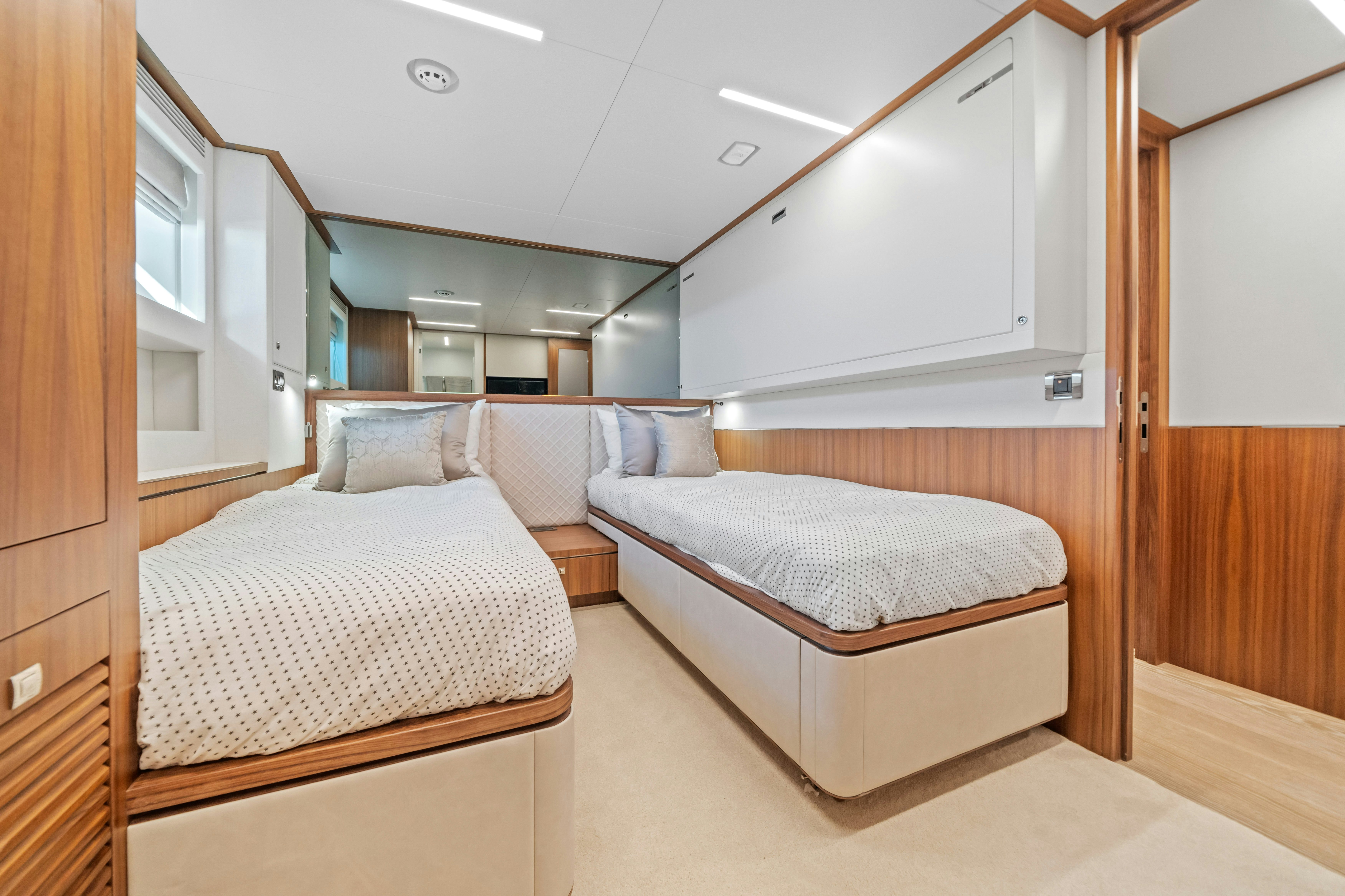 a room with two beds aboard RIO Yacht for Sale