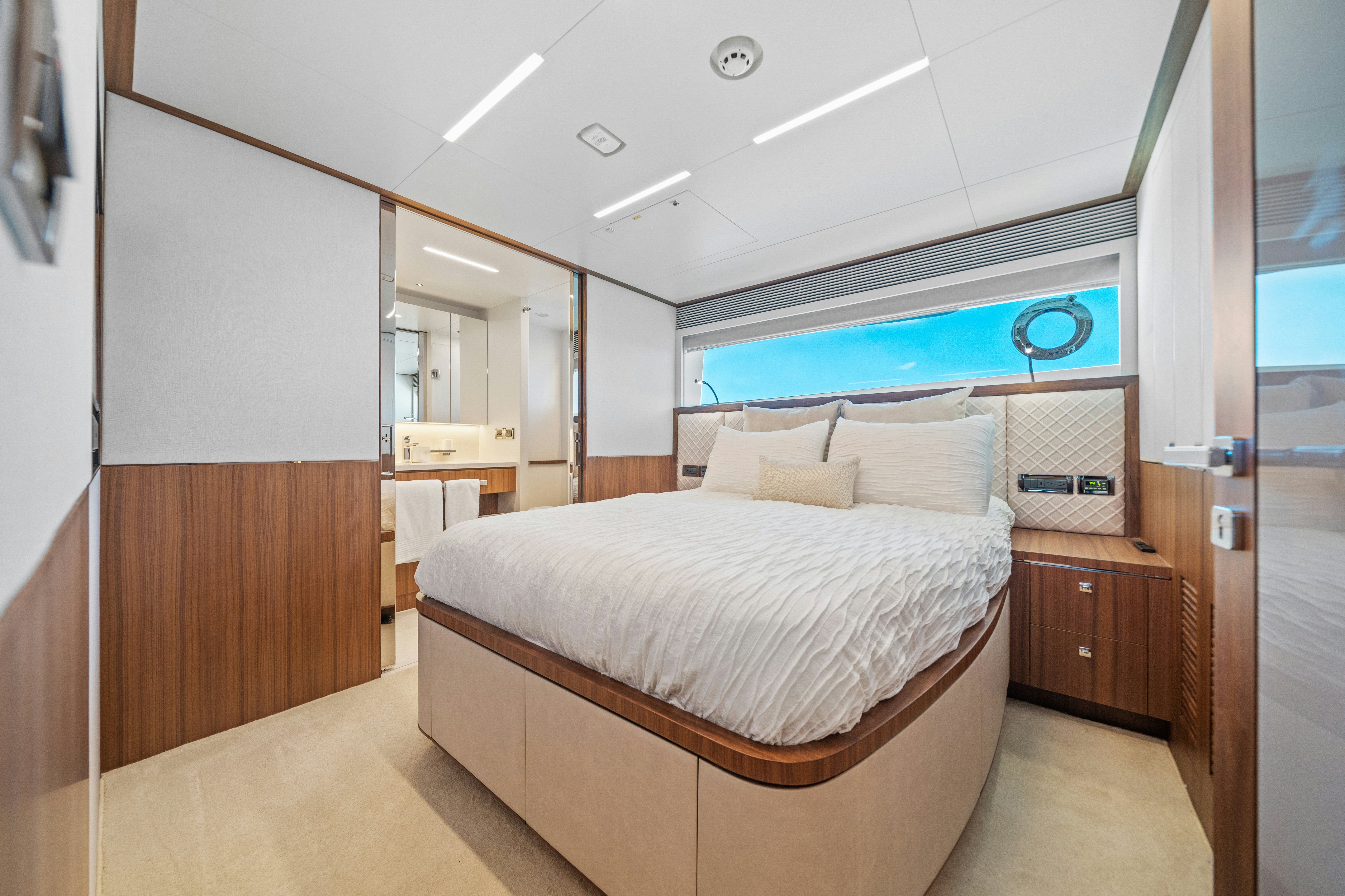 a bedroom with a bed and a mirror aboard RIO Yacht for Sale